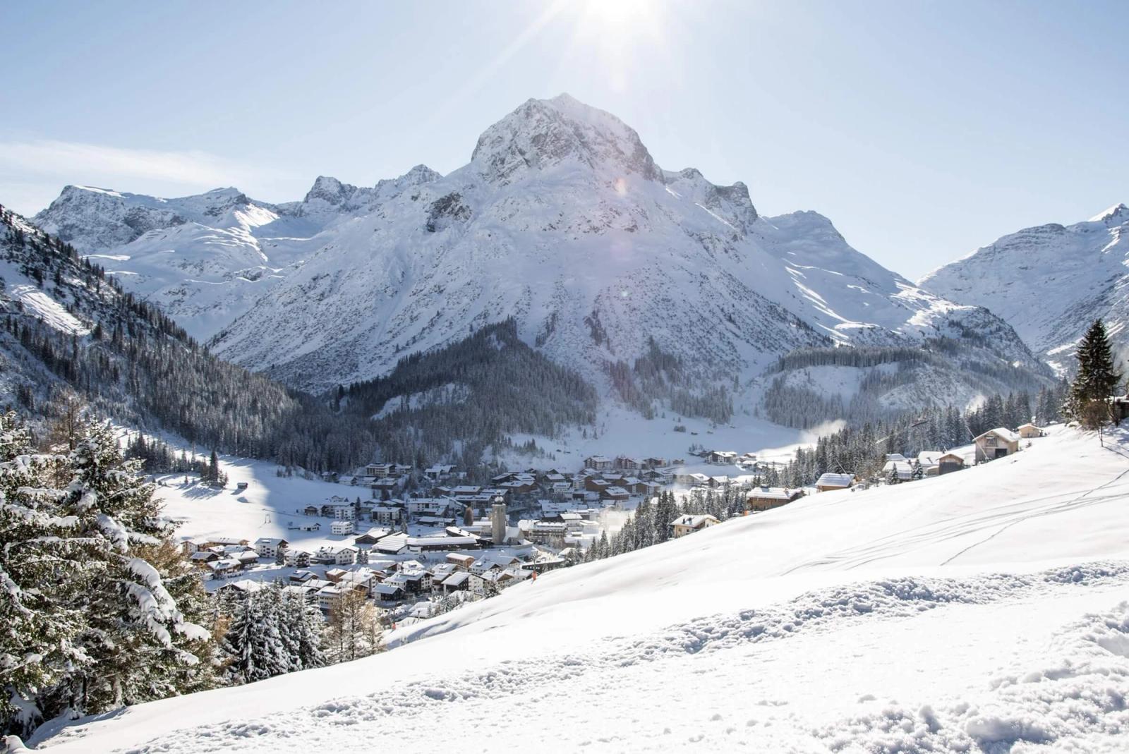 Elevated view over Lech on a sunny winder's day with the mountains behind