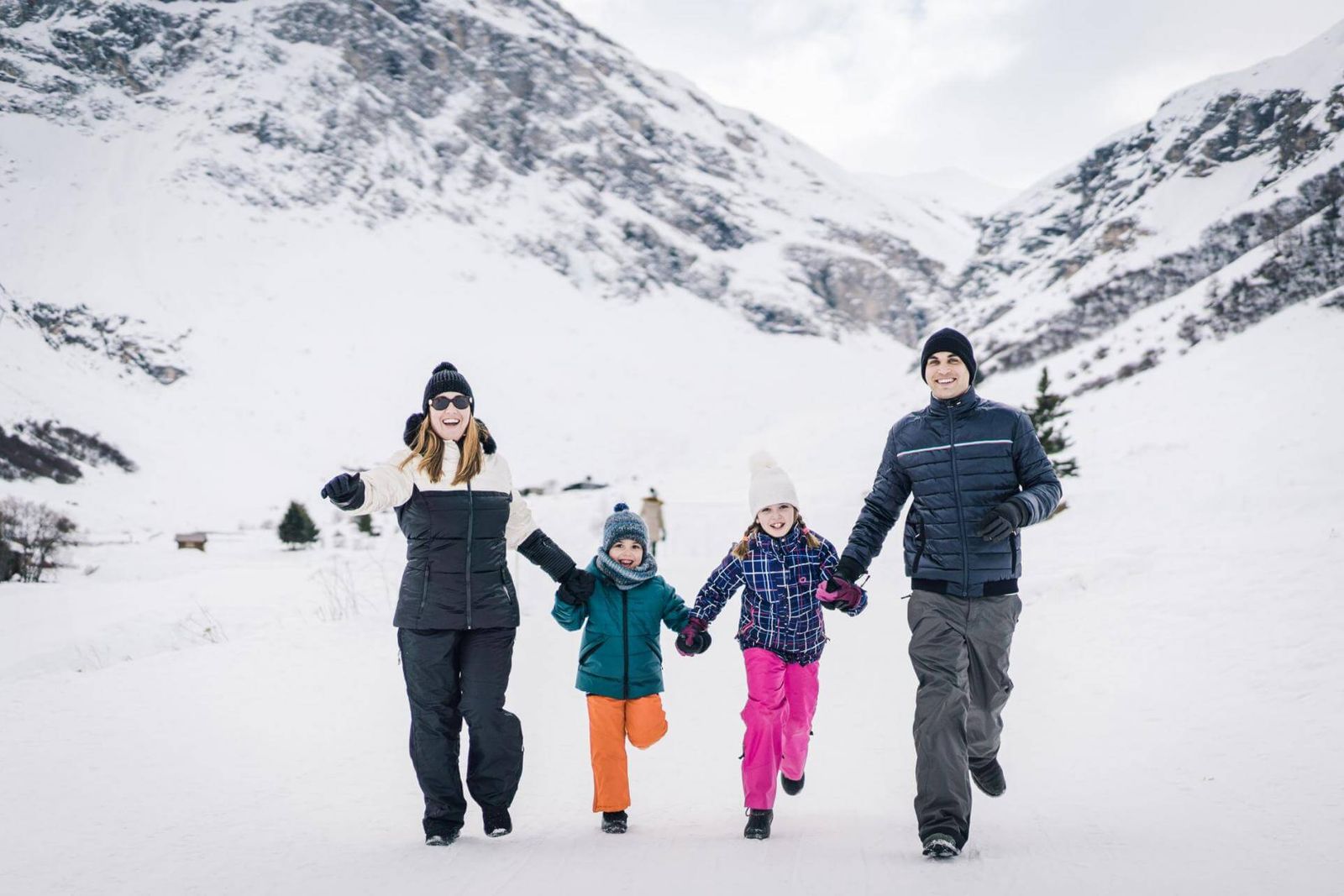 Family running through the snow