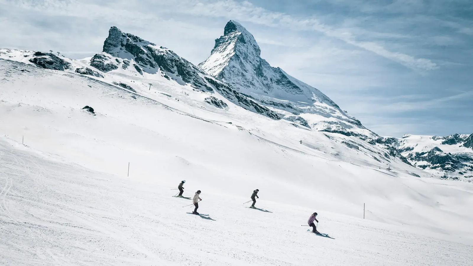Four skiers in Zermatt with the Matterhorn behind