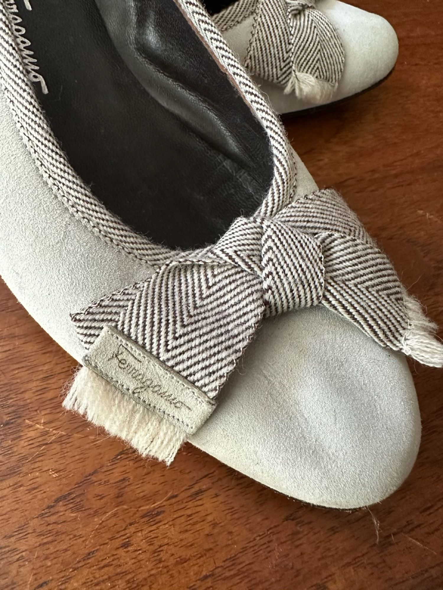 Light grey suede Ferragamo flats with a brown herringbone tweed tassel bow, size 9 1/2 B.