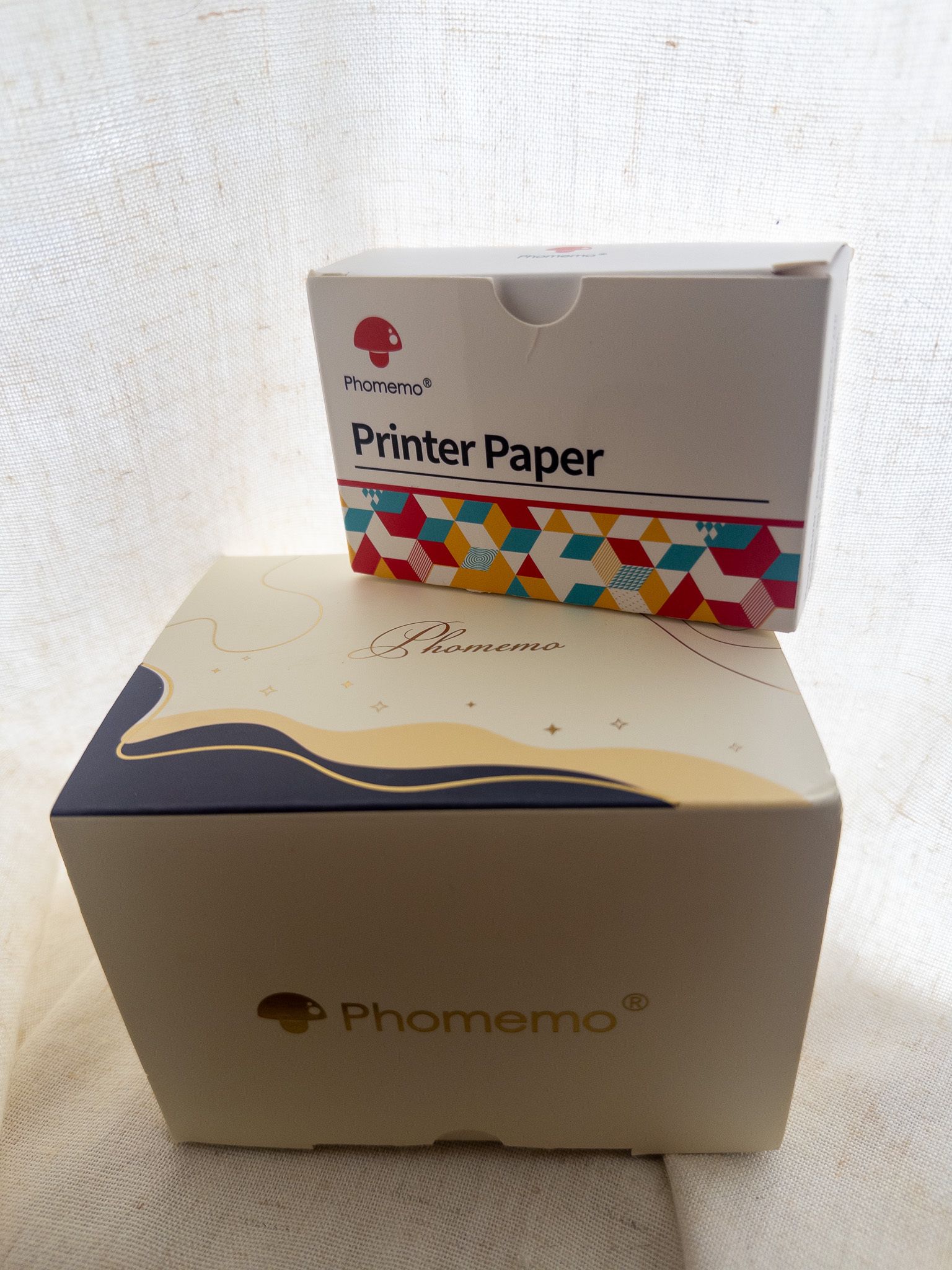 Phomemo thermal printer and included printer paper.