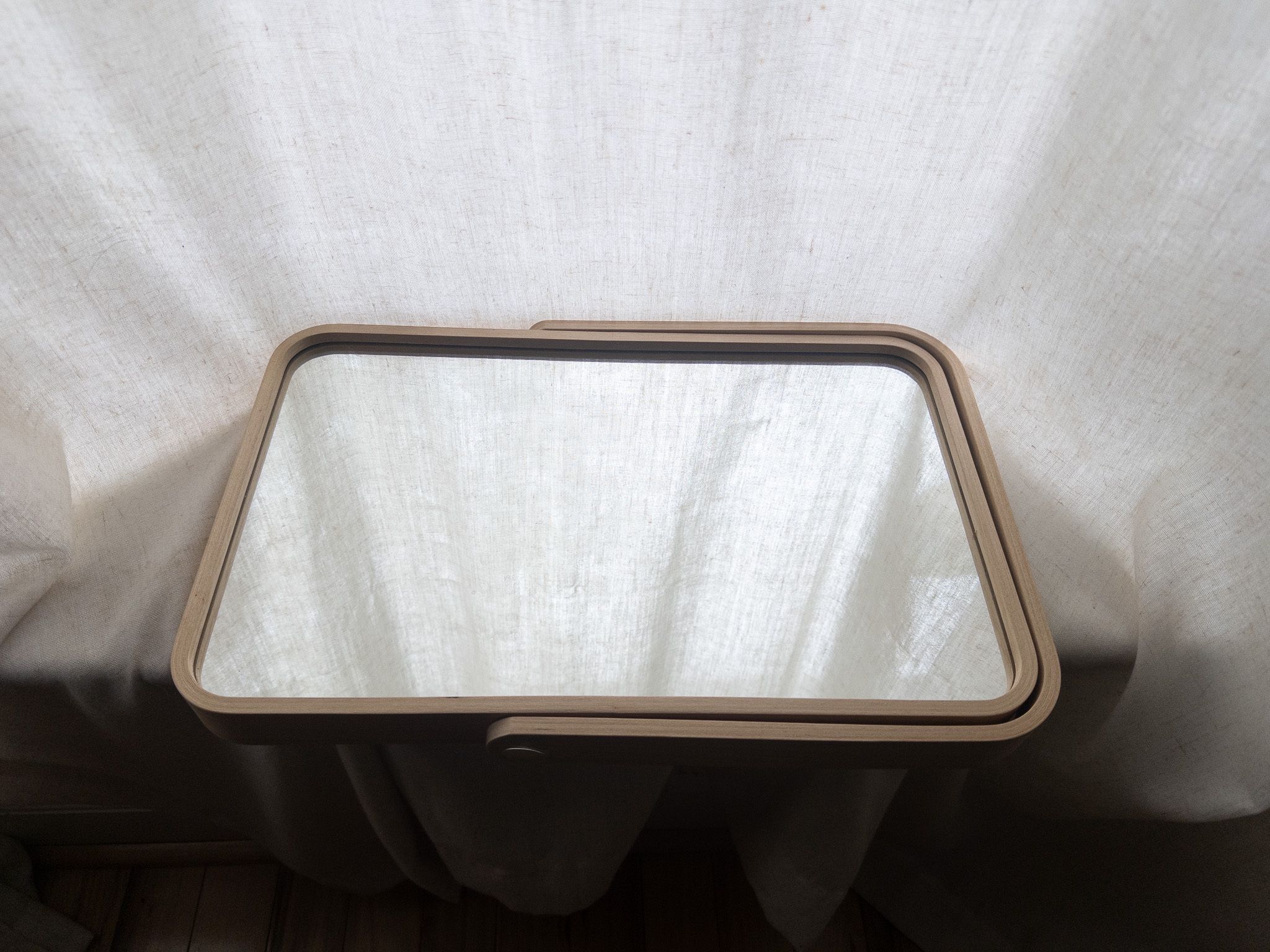 Wood-framed IKEA mirror that doubles as a tray.