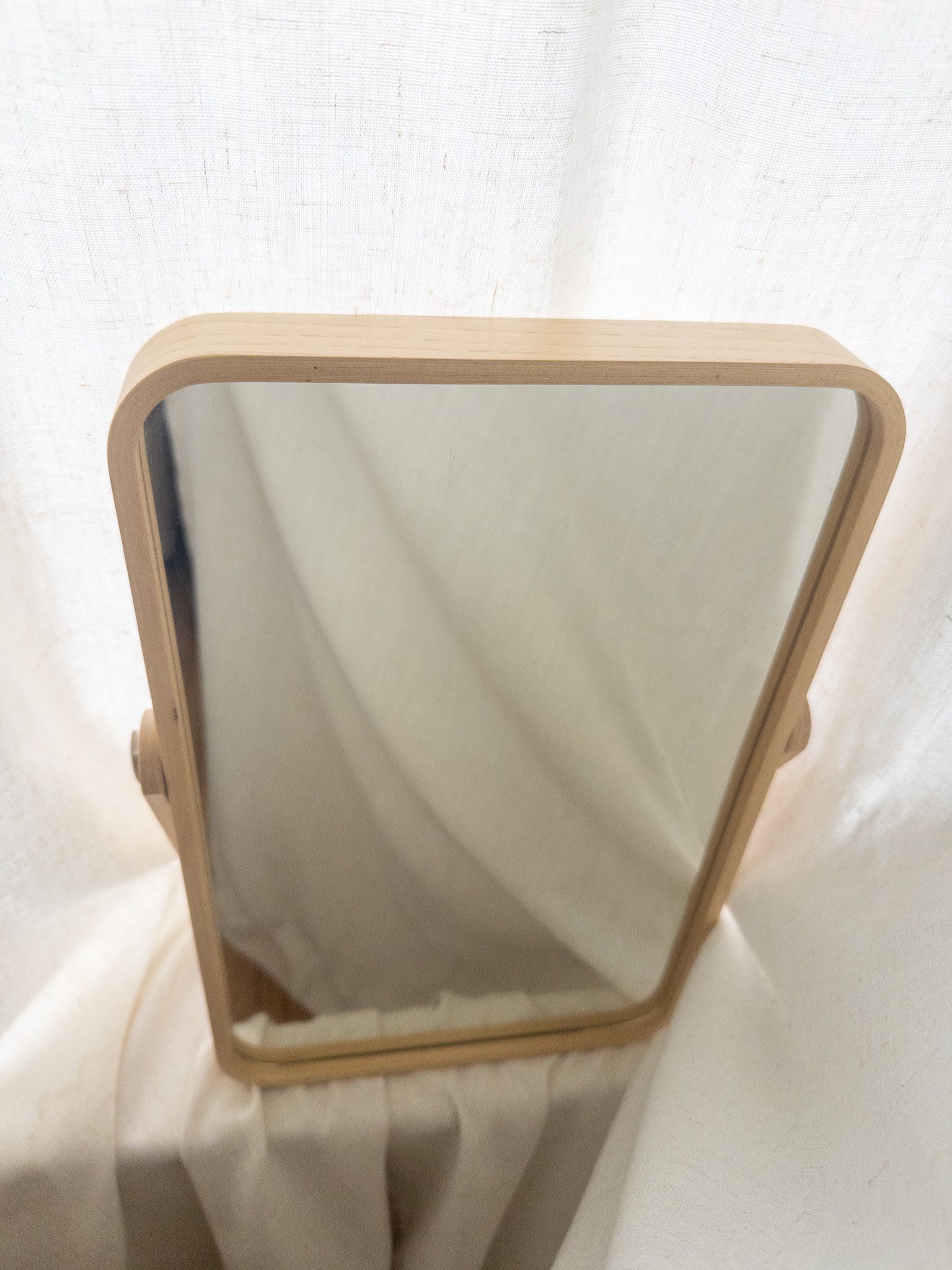 Wood-framed IKEA mirror that doubles as a tray.