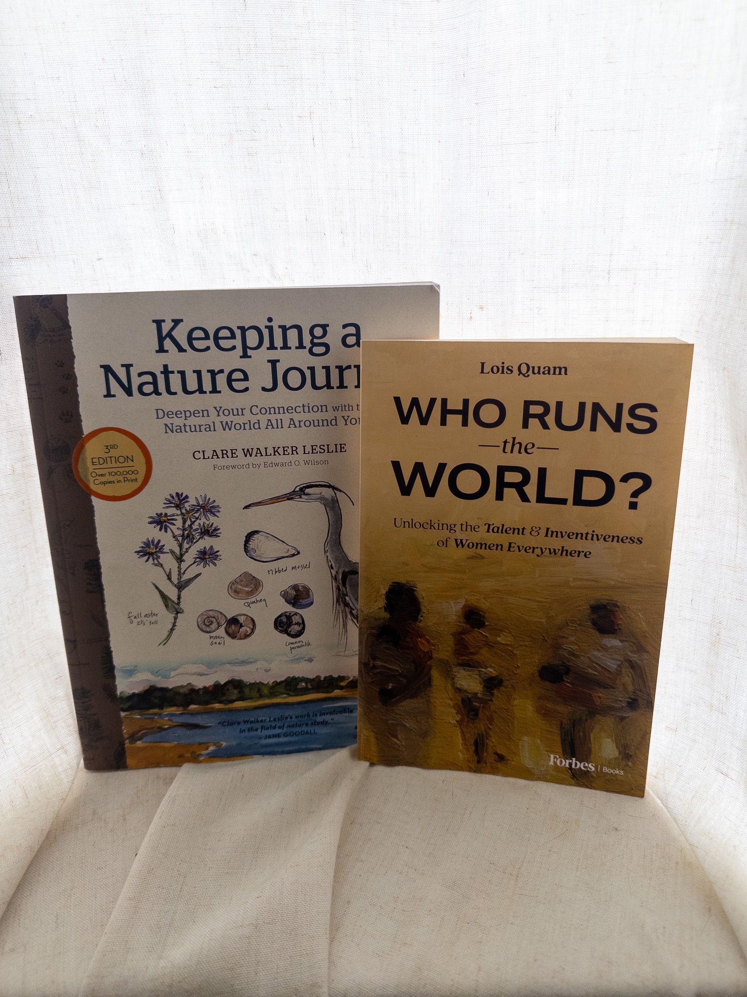 "Who Runs the World?" by Lois Quam next to "Keeping a Nature Journal".