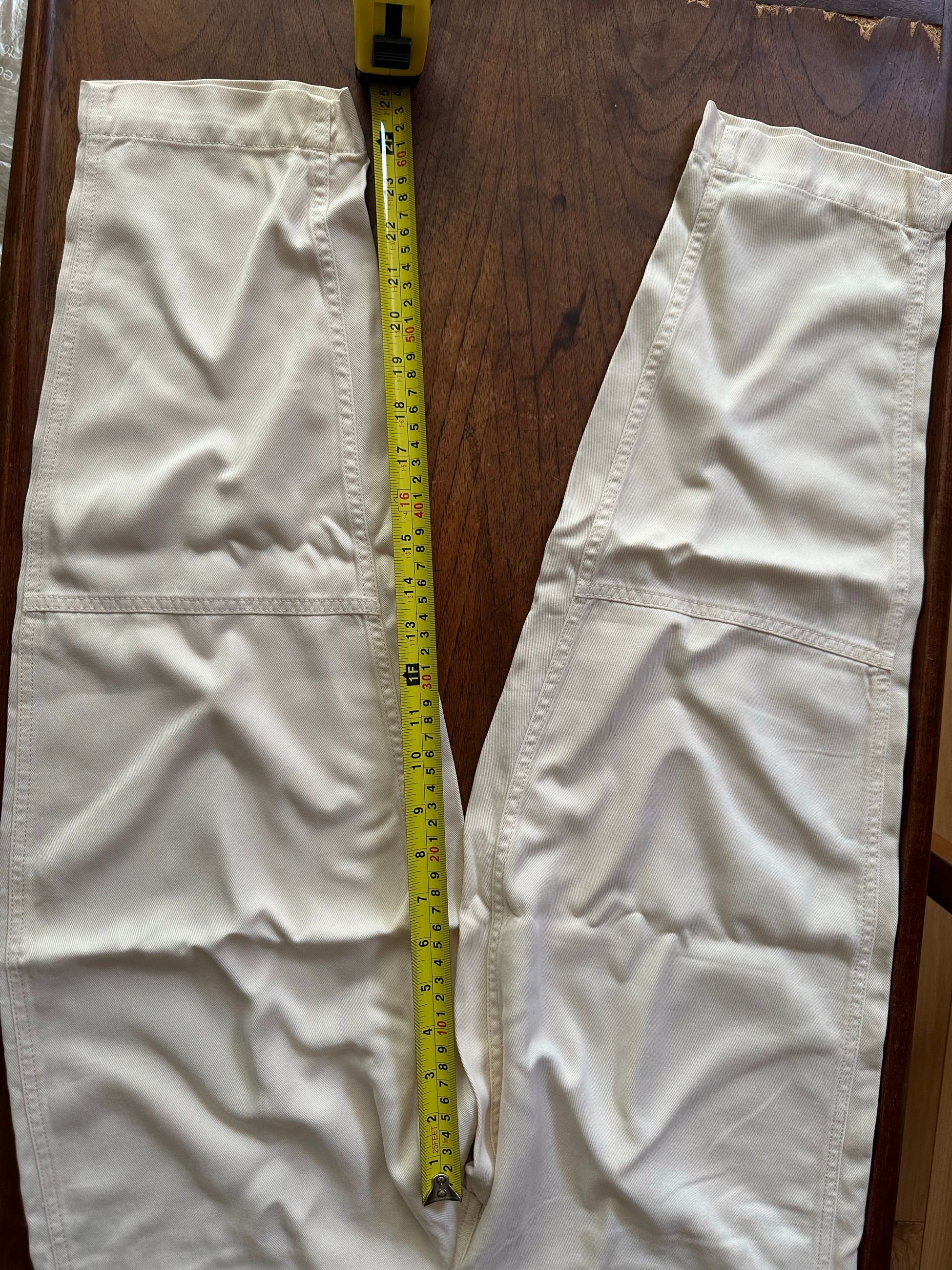 Length measurement — tape measure down the full length of the pants.