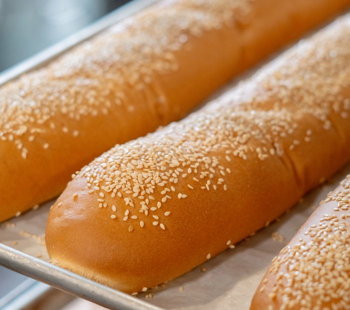 freshly baked Pals sesame roll fresh out of the oven on tray