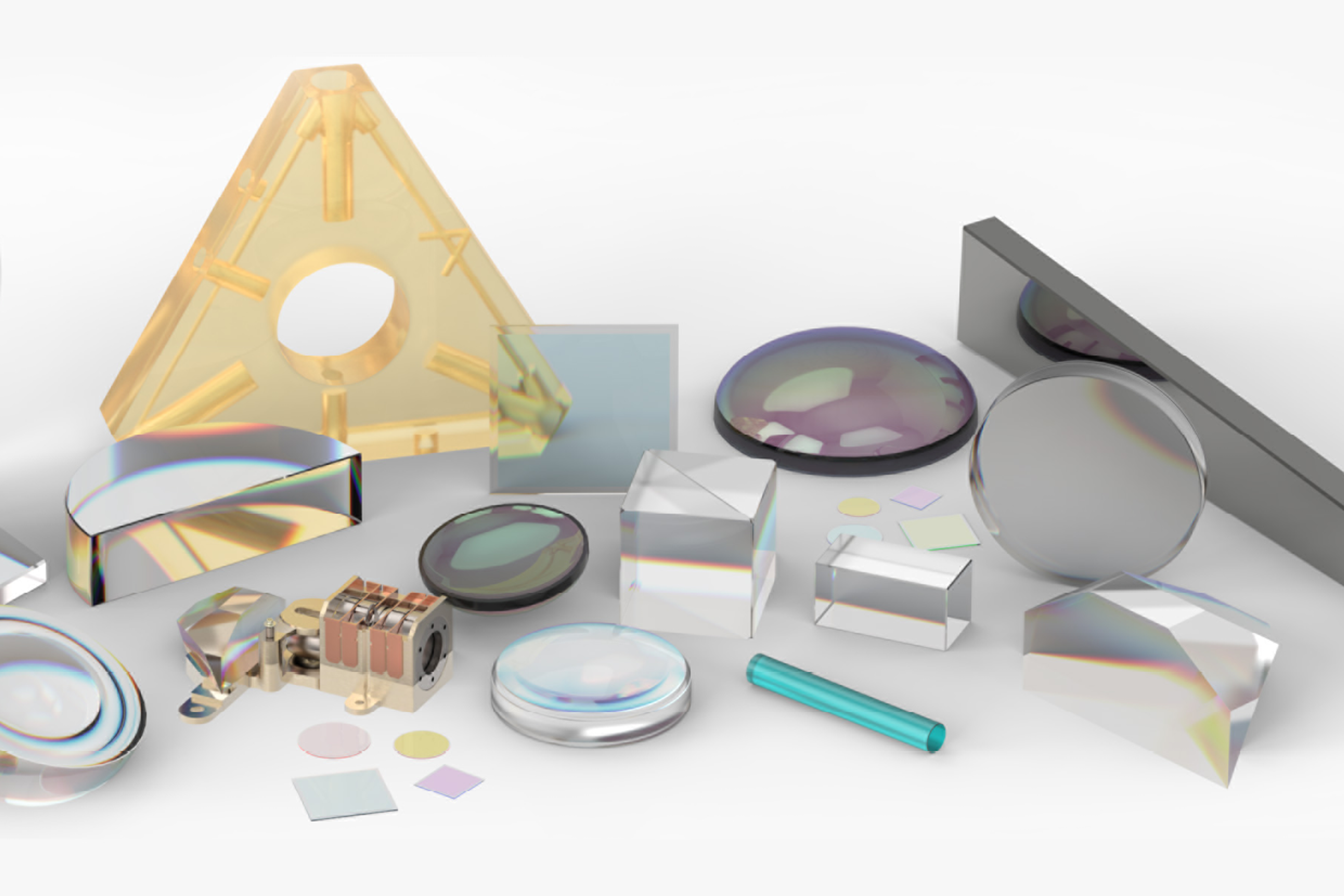 A selection of superpolished precision optics - A variety of precision optical components displayed on a white surface, including polished lenses, prisms, mirrors, windows, and coated glass elements. The objects are made from transparent and semi-reflective materials in various shapes such as circular, triangular, cylindrical, and rectangular. One notable component is a yellow triangular optic with a central hole, surrounded by smaller components and a gold-toned mechanical part. The surfaces exhibit high clarity and smoothness, showcasing the results of advanced optical superpolishing.