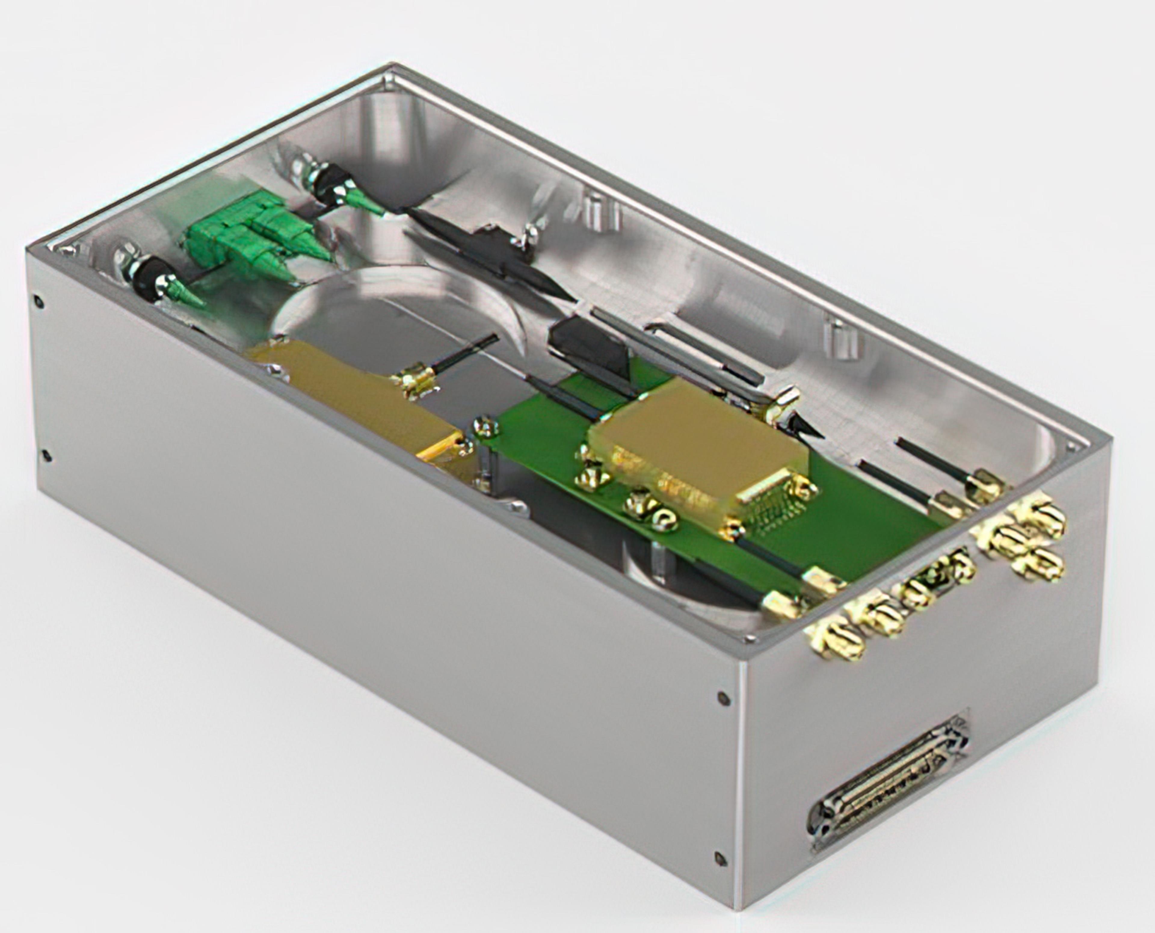 Compact photonic laser engine module featuring precision optical components, fiber connections, and integrated electronics in a metal housing