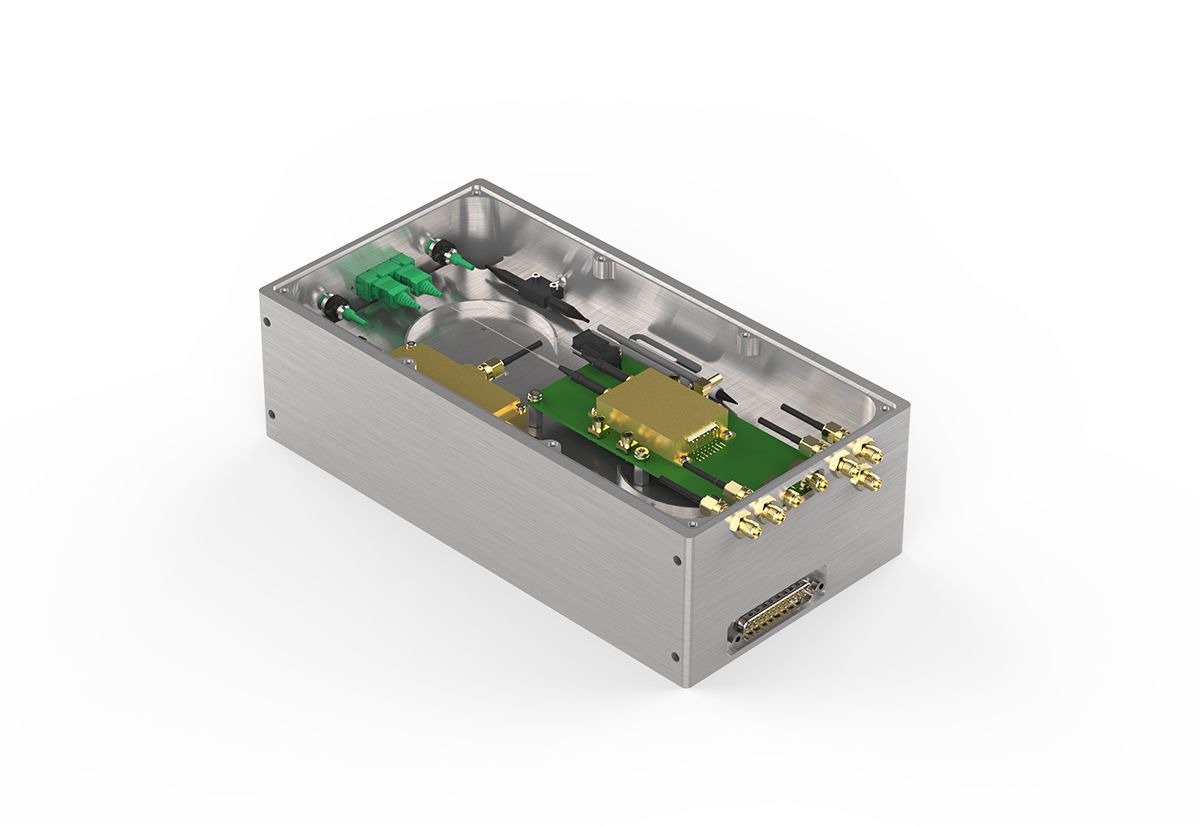 Compact photonic laser engine module featuring precision optical components, fiber connections, and integrated electronics in a metal housing