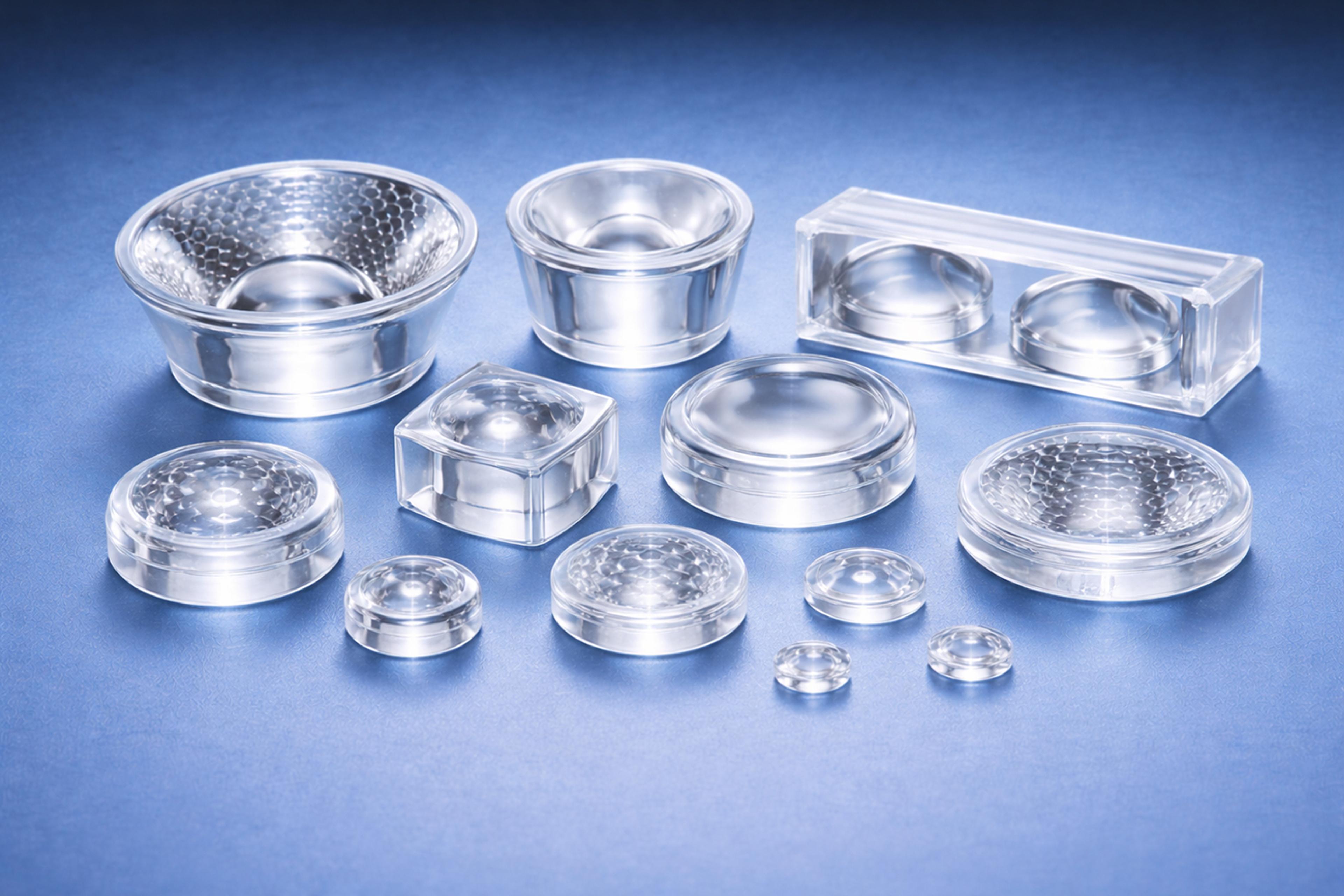A selection of total internal reflection (TIR) polymer optic lenses on a blue graduated background