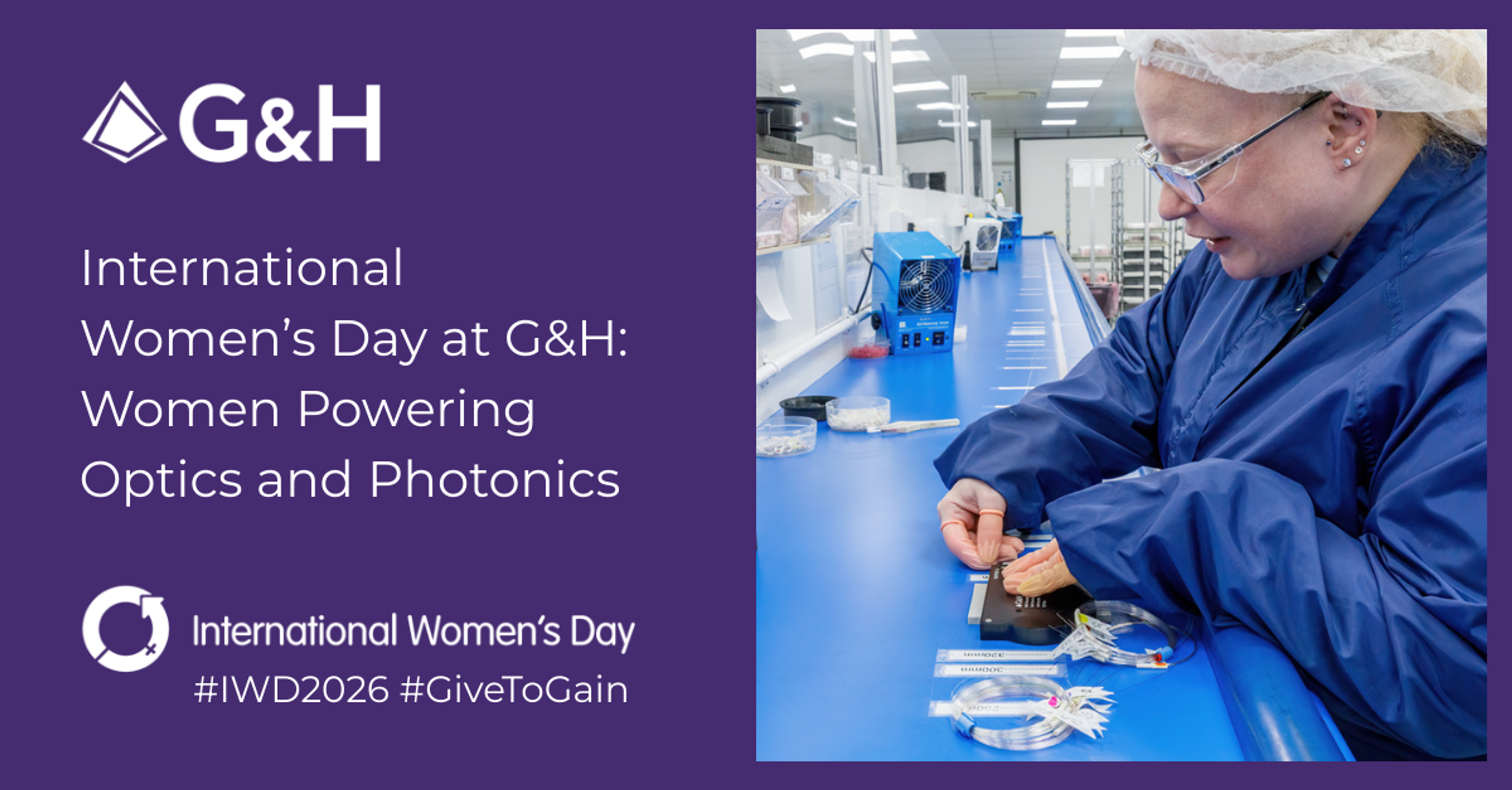 International Women’s Day at G&H graphic with the headline “Women Powering Optics and Photonics,” featuring a technician in safety glasses working with fibre-optic components on a blue lab bench, plus the G&H logo and hashtags #IWD2026 and #GiveToGain.