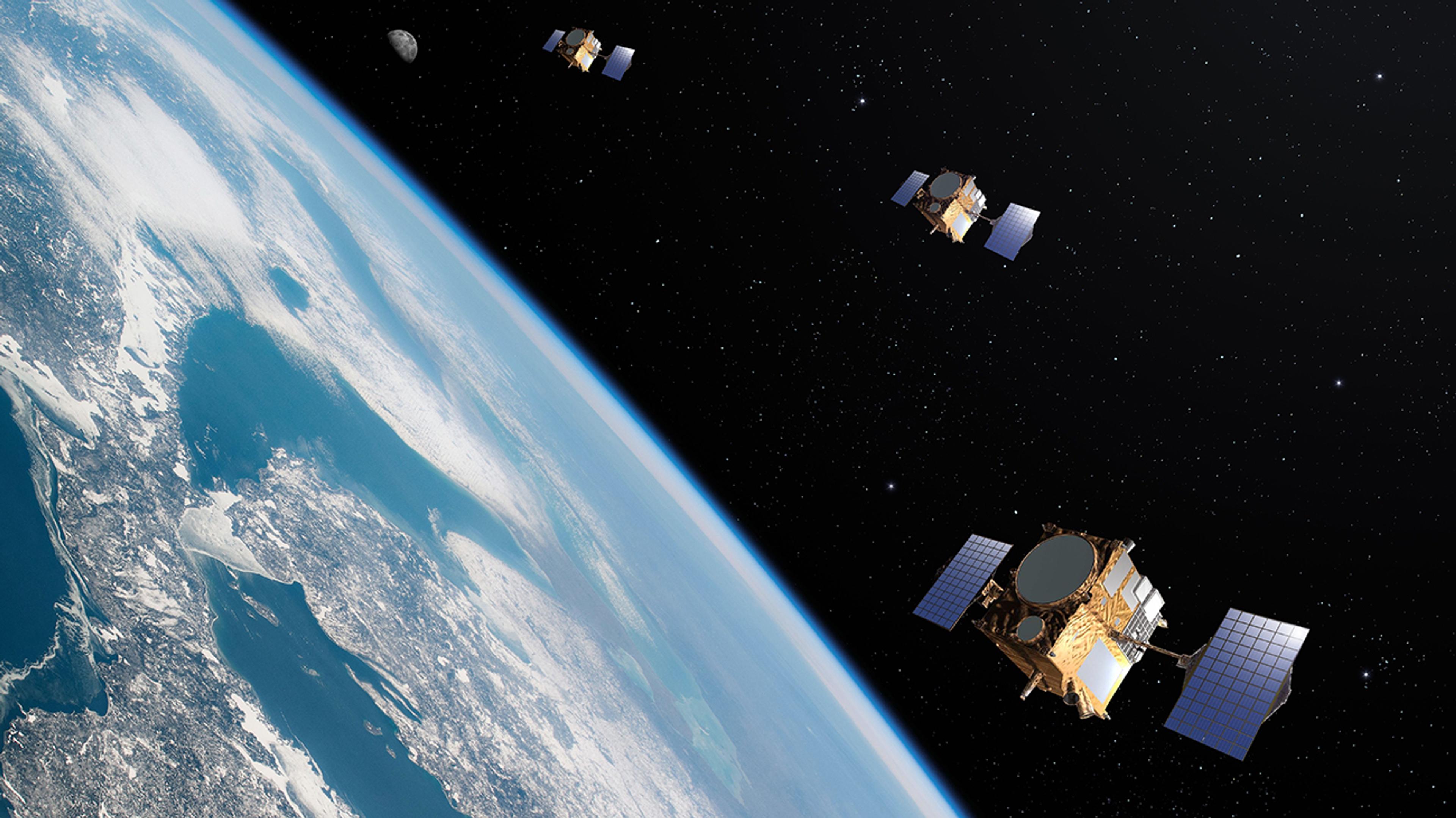 Image showing three satellites orbiting over Earth as part of a constellation