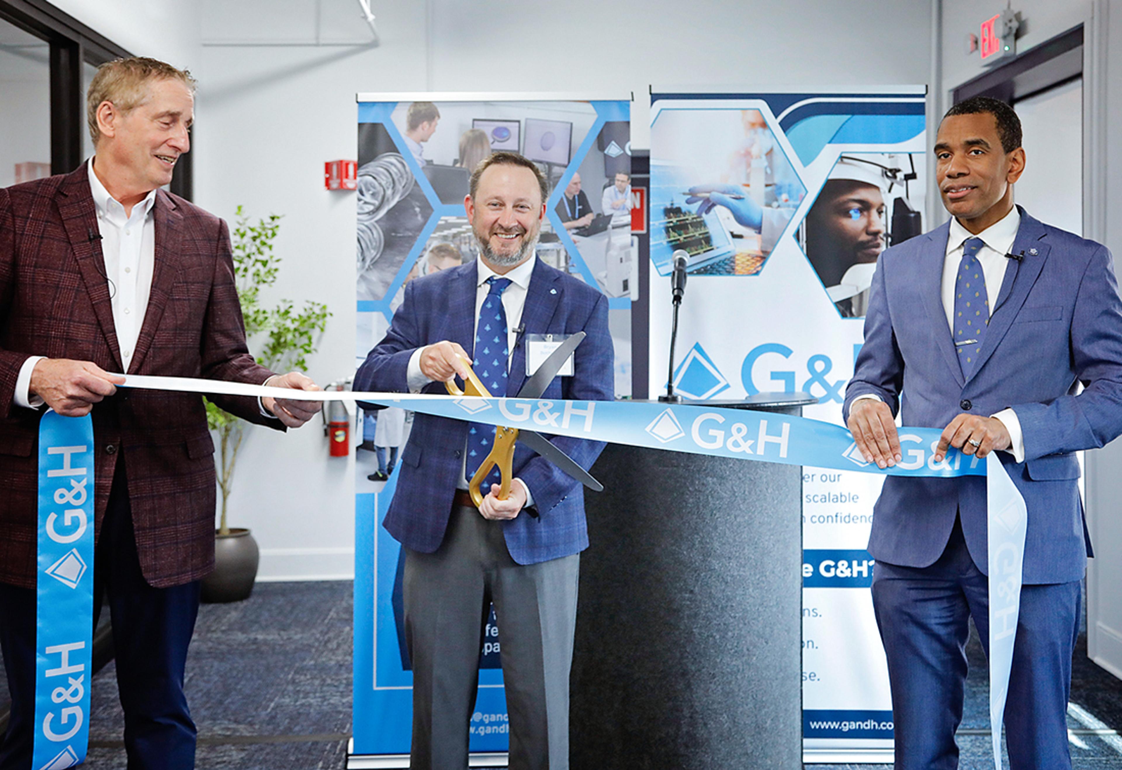 G&H Innovation Hub for Life Sciences Grand Opening Ribbon Cutting with 2 prestigious guest and Bryan cutting the ribbon with a huge pair of scissors