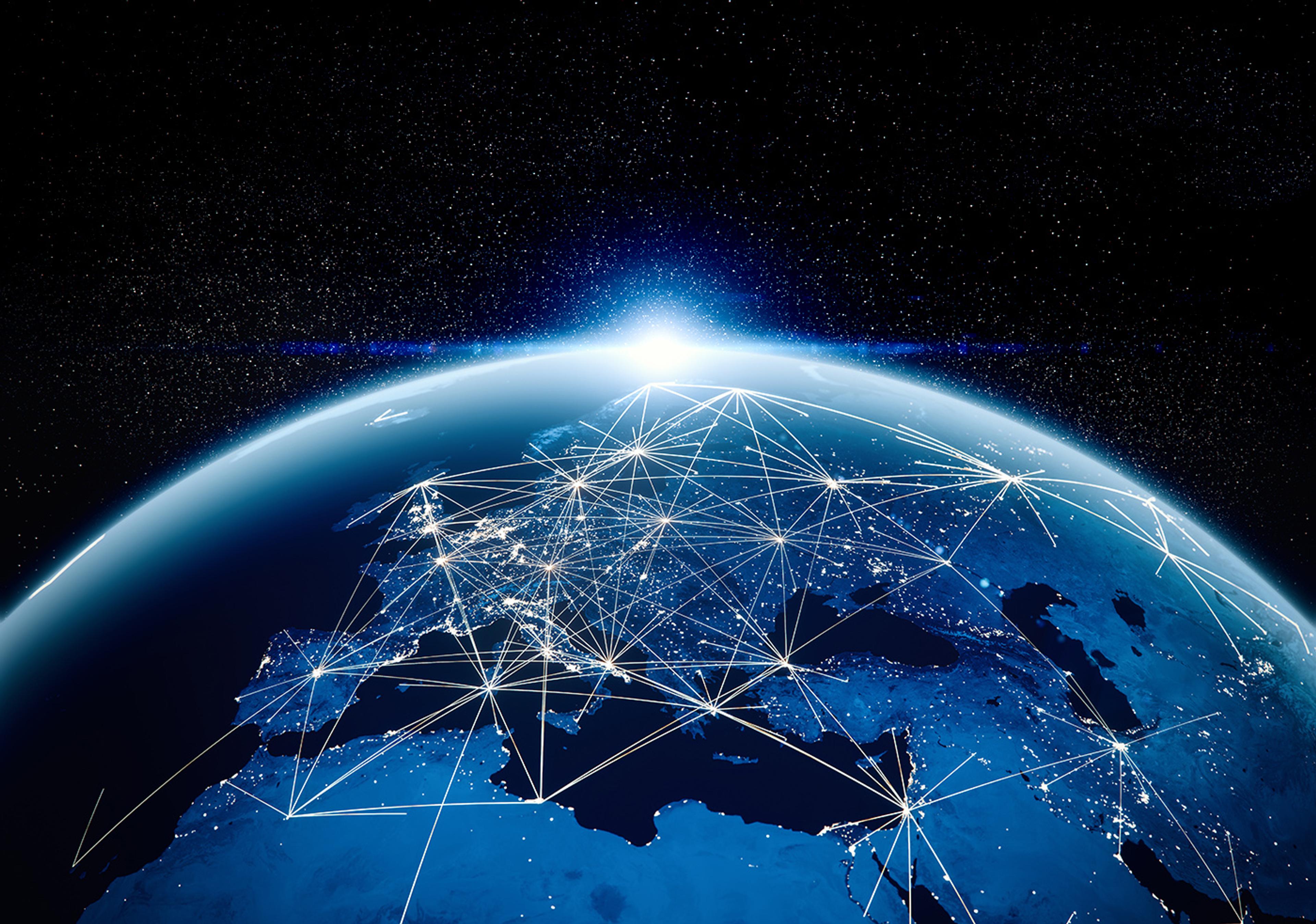 View of Earth from space with glowing network lines connecting points across Europe, illustrating global communications against a starry background.