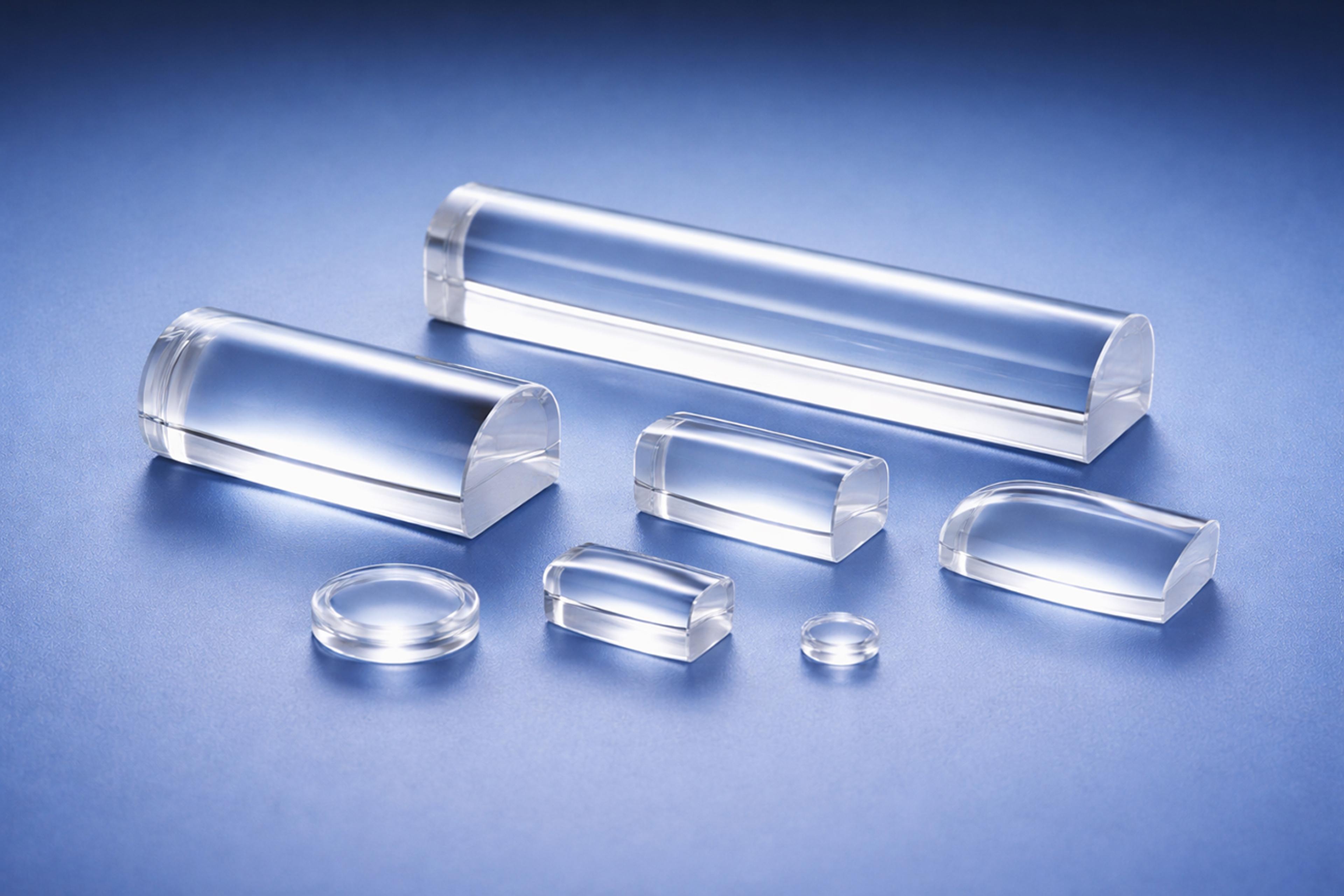 A selection of Cylindrical polymer optic lenses on a blue graduated background