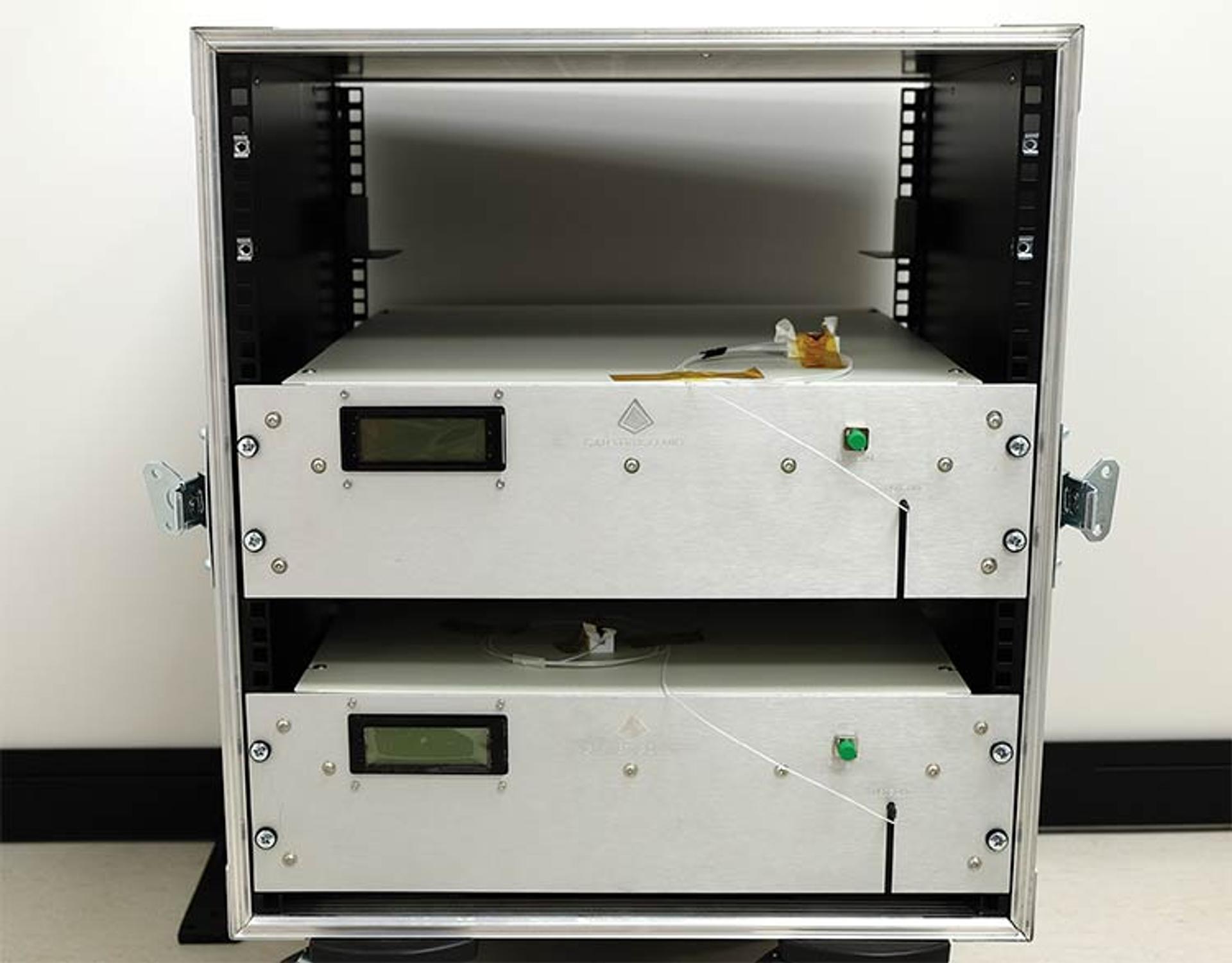 Two G&H rack-mounted fiber amplifier units with front-panel displays and optical fiber connections, housed in an open equipment cabinet.