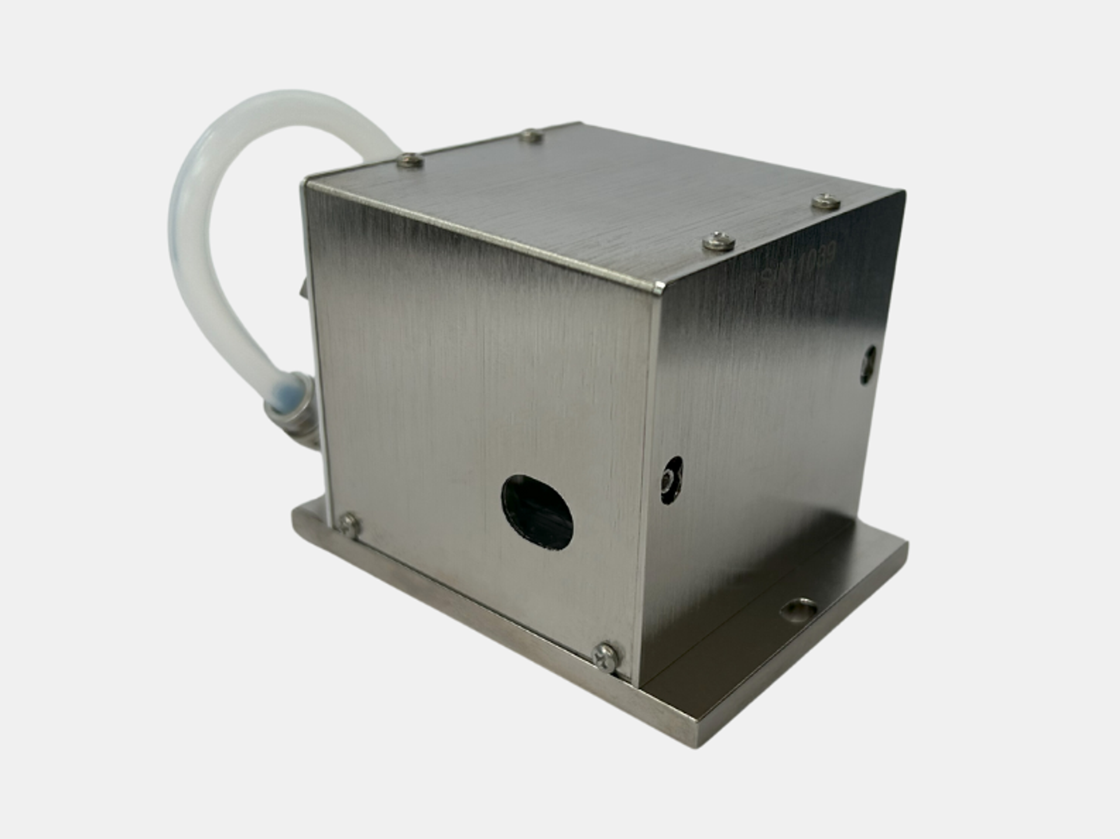 AODF-UV A compact, stainless steel industrial device with a rectangular metal housing mounted on a flat base. The front face has a circular black opening and a small port or screw hole. A translucent flexible tube is attached at the back, curving upward and to the side. The unit is secured with multiple small screws on the top and sides, and the brushed metal finish gives it a clean, durable appearance. The background is plain white, emphasizing the device's design