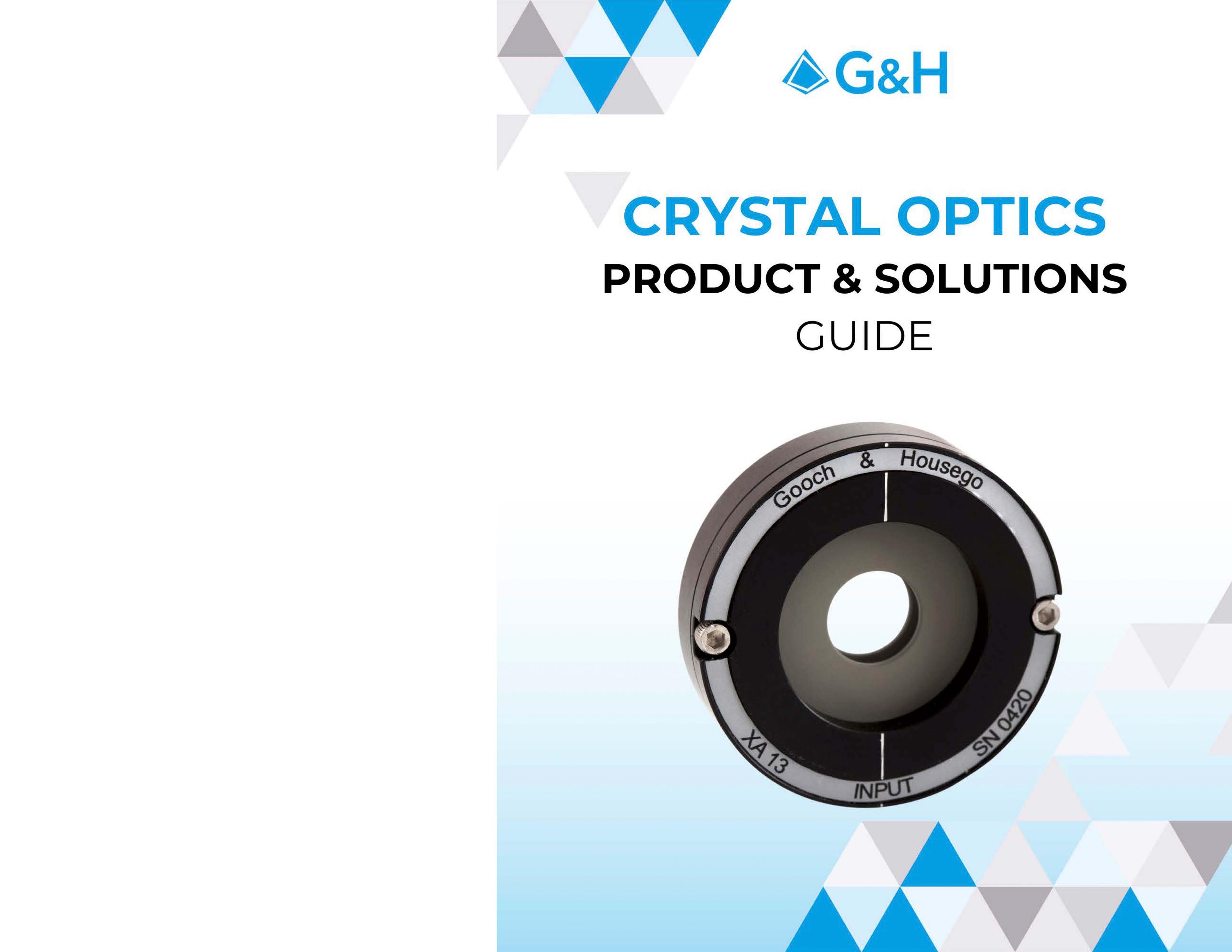 G&H Product & Solutions Guide - Crystal Optics Page 01. Cover of the "G&H Crystal Optics Product & Solutions Guide." The central image is a round optical component labeled "Gooch & Housego" with additional markings "INPUT," "XA13," and "SN0420." The title text above the image reads: "CRYSTAL OPTICS PRODUCT & SOLUTIONS GUIDE" with "CRYSTAL OPTICS" in blue and the rest in black. The background includes a gradient from white to light blue, along with a pattern of triangular graphics in shades of blue, gray, and white. The G&H logo is prominently displayed at the top.