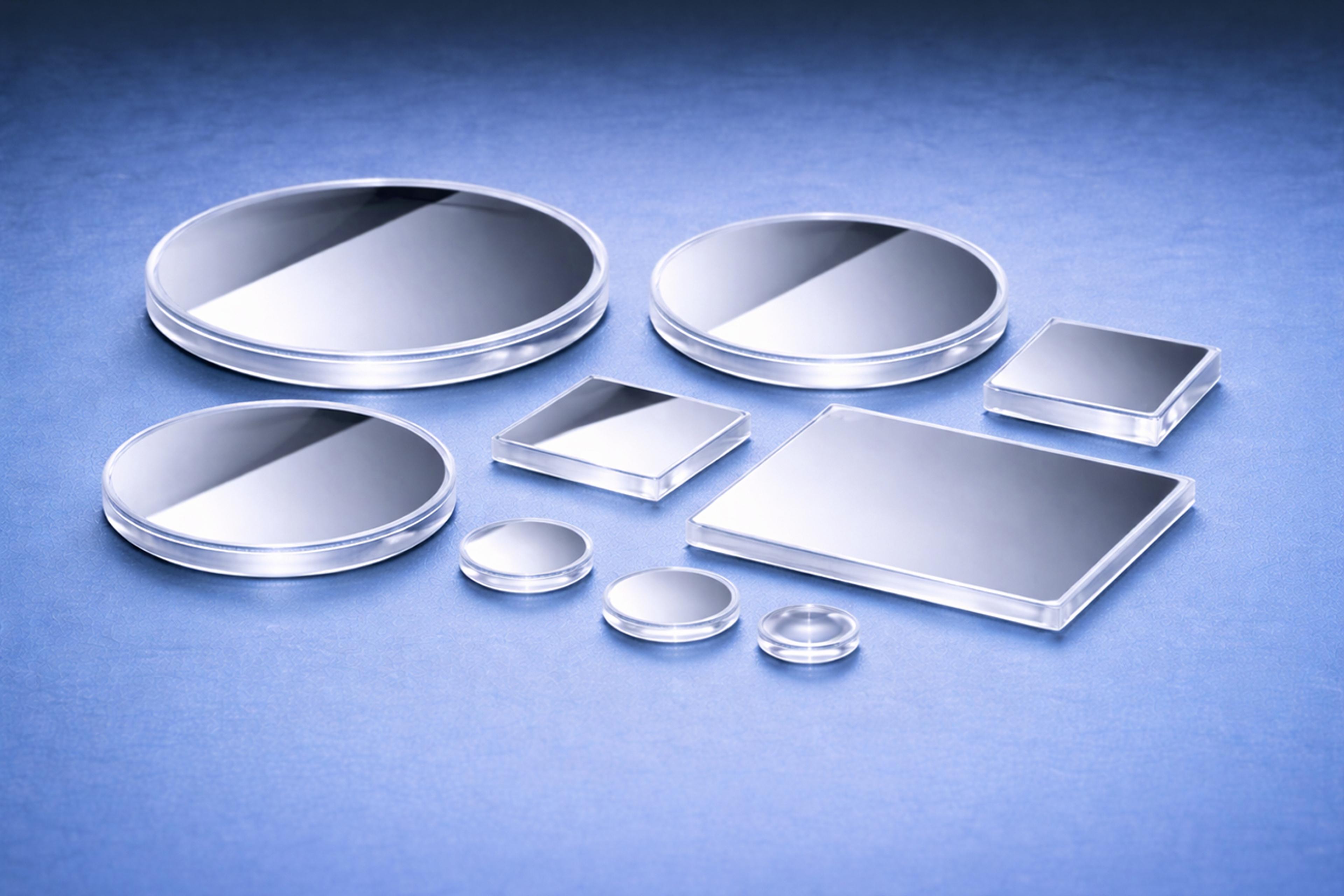 A selection of polymer optic mirrors on a blue graduated background