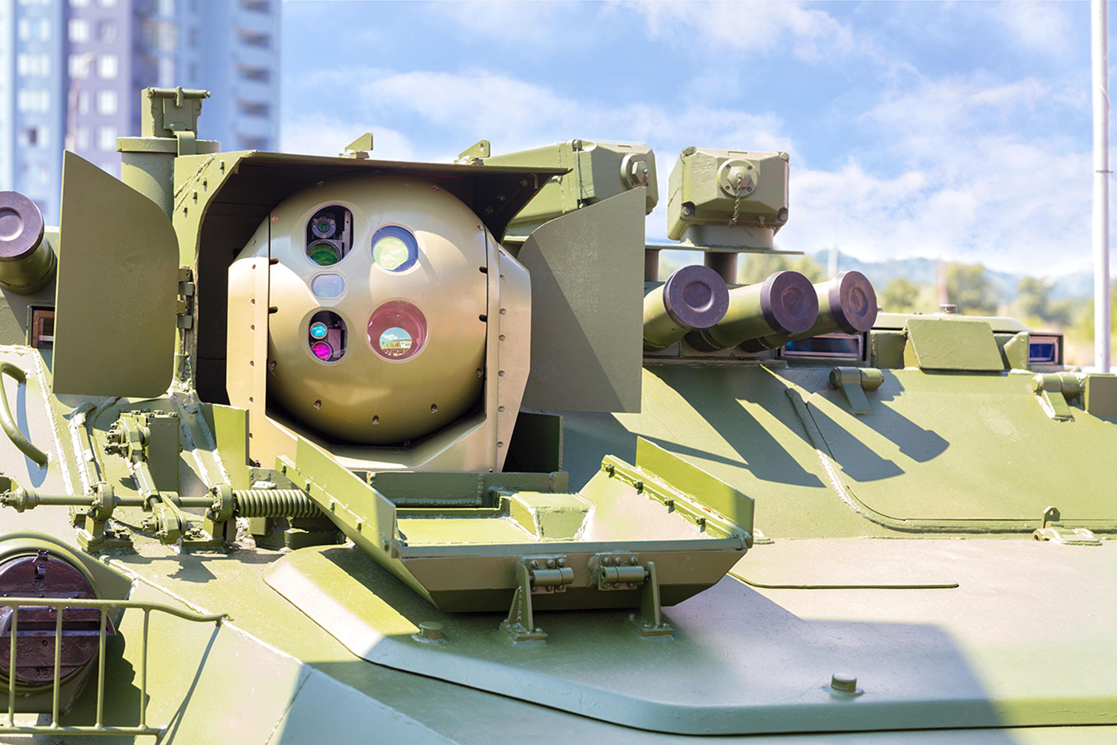 Tank vision systems - Close-up view of an advanced targeting and surveillance system mounted on a military armored vehicle, showing multiple optical lenses and sensors