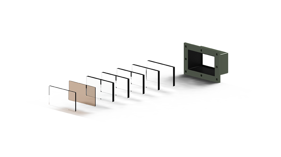 Vision Block Exploded View image - An exploded view rendering of a vision block assembly, showing multiple transparent and tinted rectangular optical elements aligned in sequence. The optical elements lead into a dark green, rectangular housing frame with screw holes, illustrating the internal structure and component layering