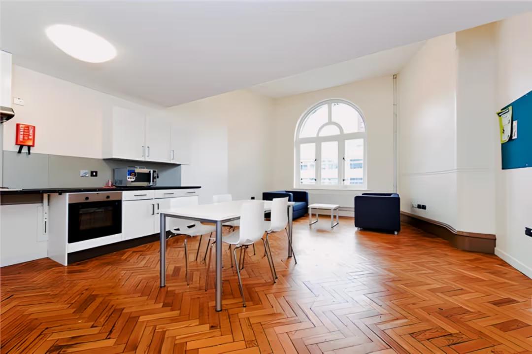 Spacious shared kitchen and lounge area designed for cooking, dining, and socialising.
