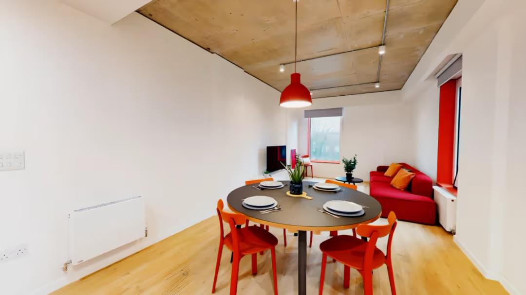 Spacious shared dining and lounge area designed for meals, relaxation, and socialising.