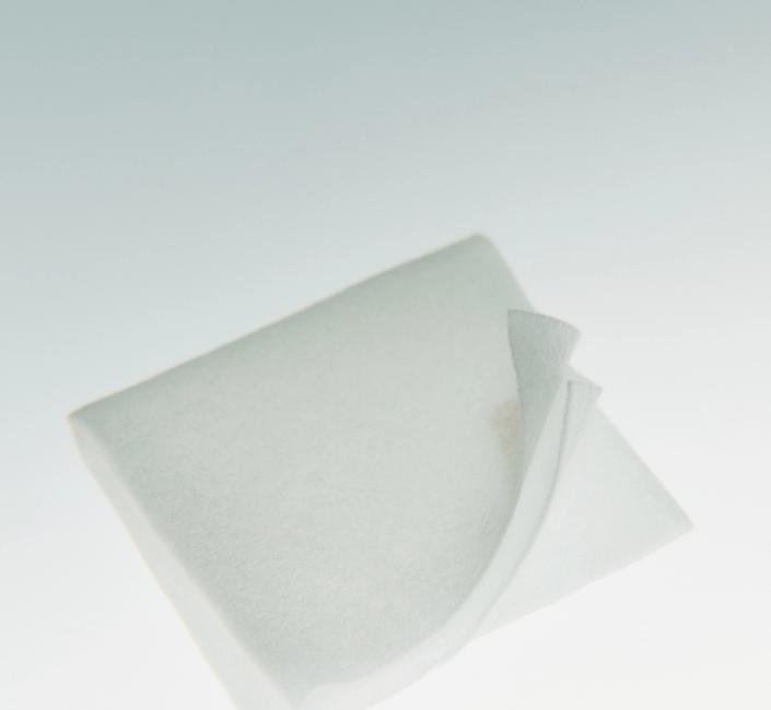 A white, translucent square sheet with one corner gently curled upward.