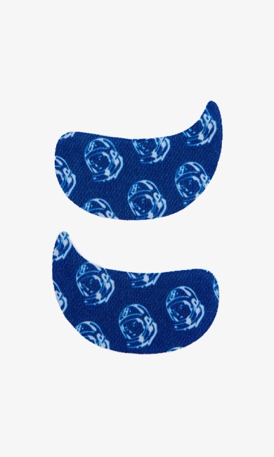 Two blue eye patches patterned with white astronaut helmets.