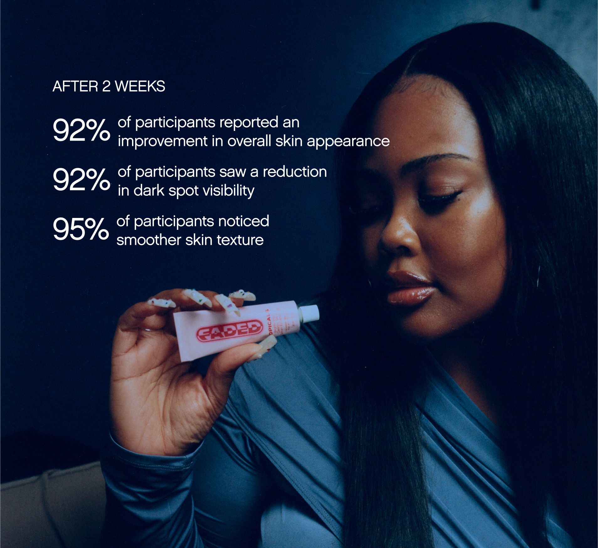 a woman is holding a tube of cream in her hand .