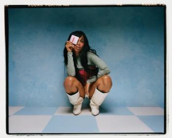 Girl holding Peel Pads product in blue room