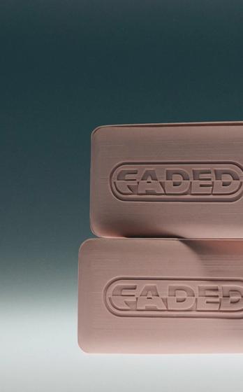 Two pink FADED soap bars, a "FADED TOPICALS" cream tube, and two FADED eye patches against a teal background.