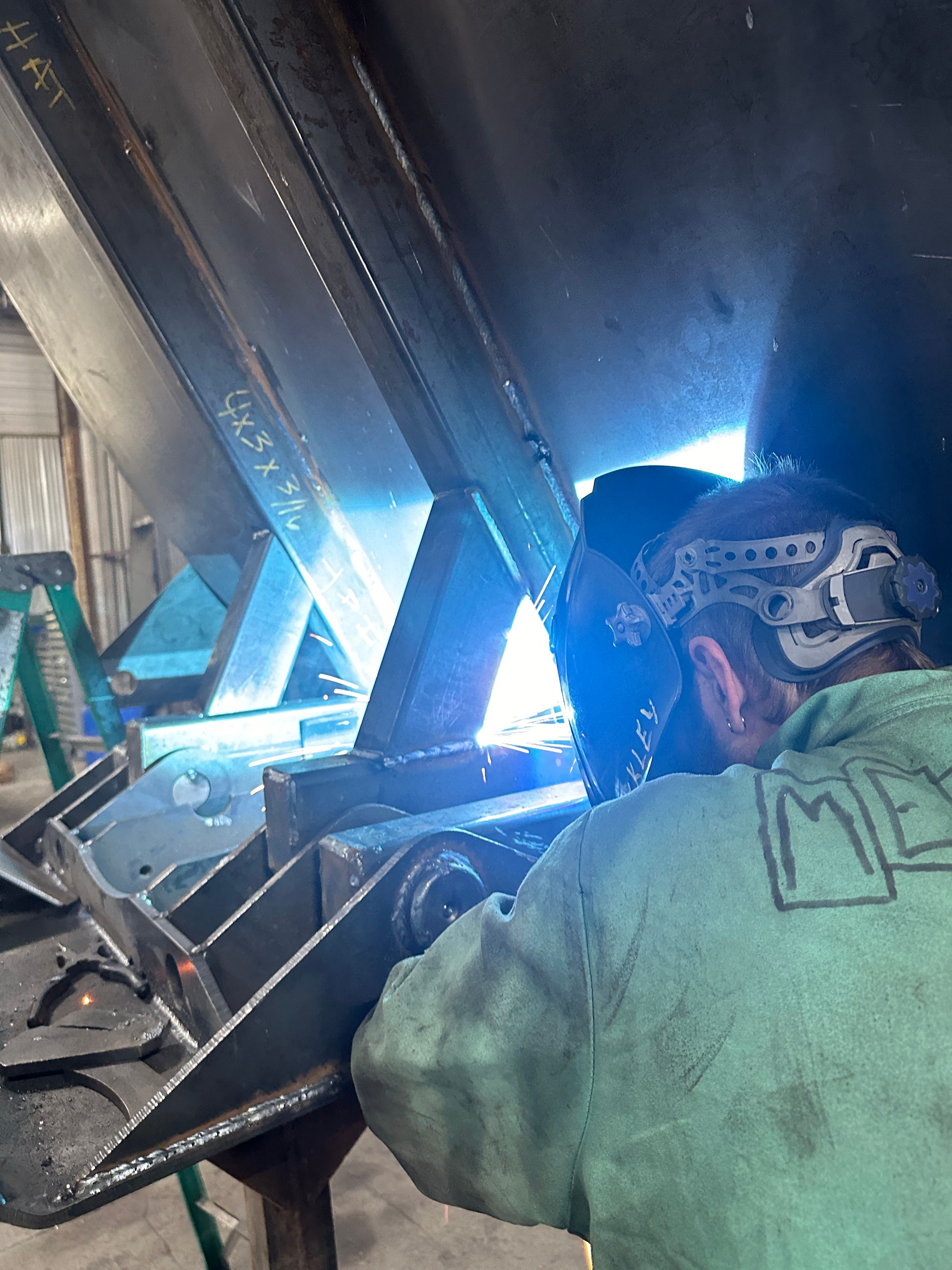 Worker welding custom alko trailer