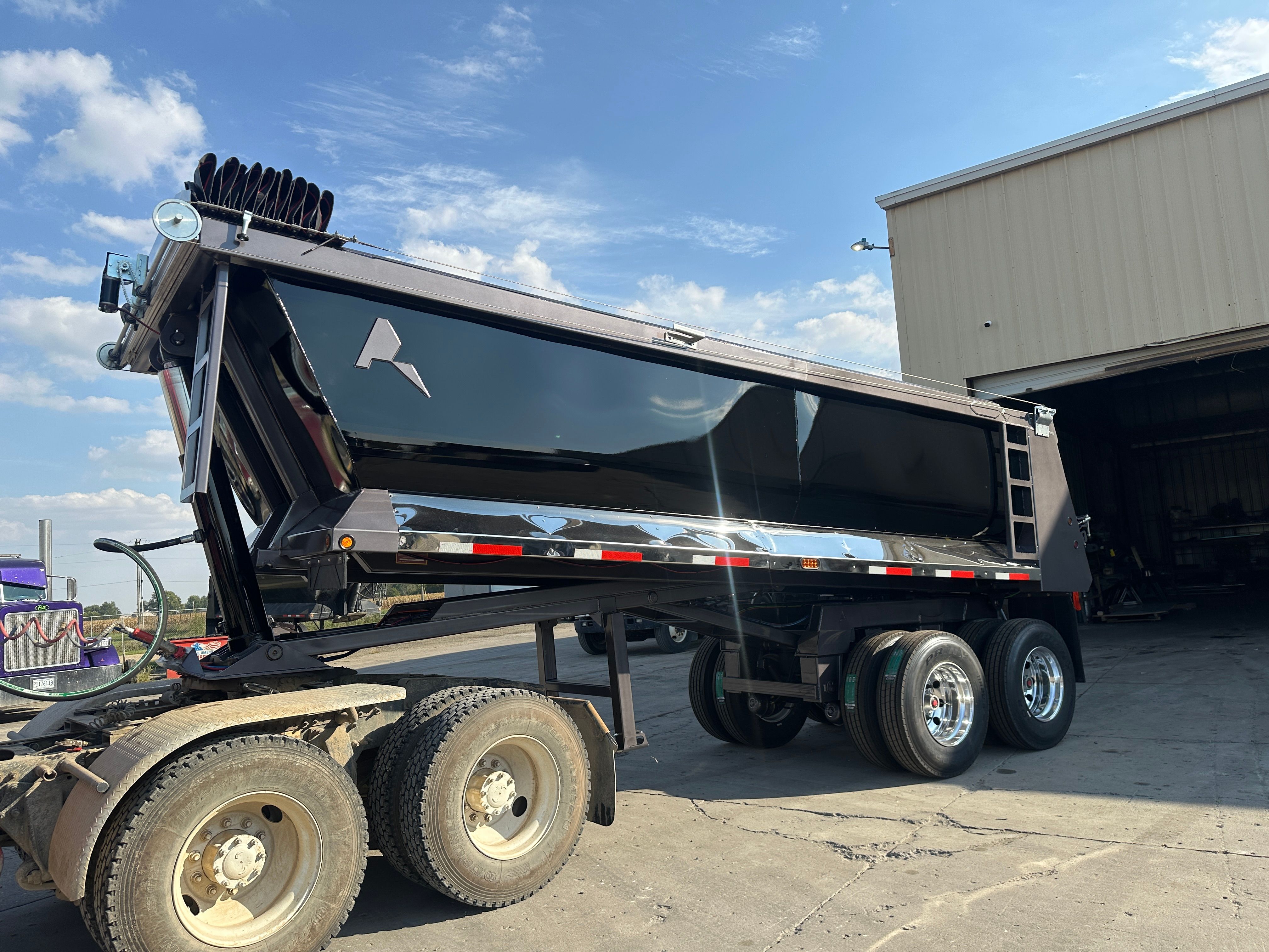 Dump trailer hauling rip rap on a Cedar Rapids levee construction site