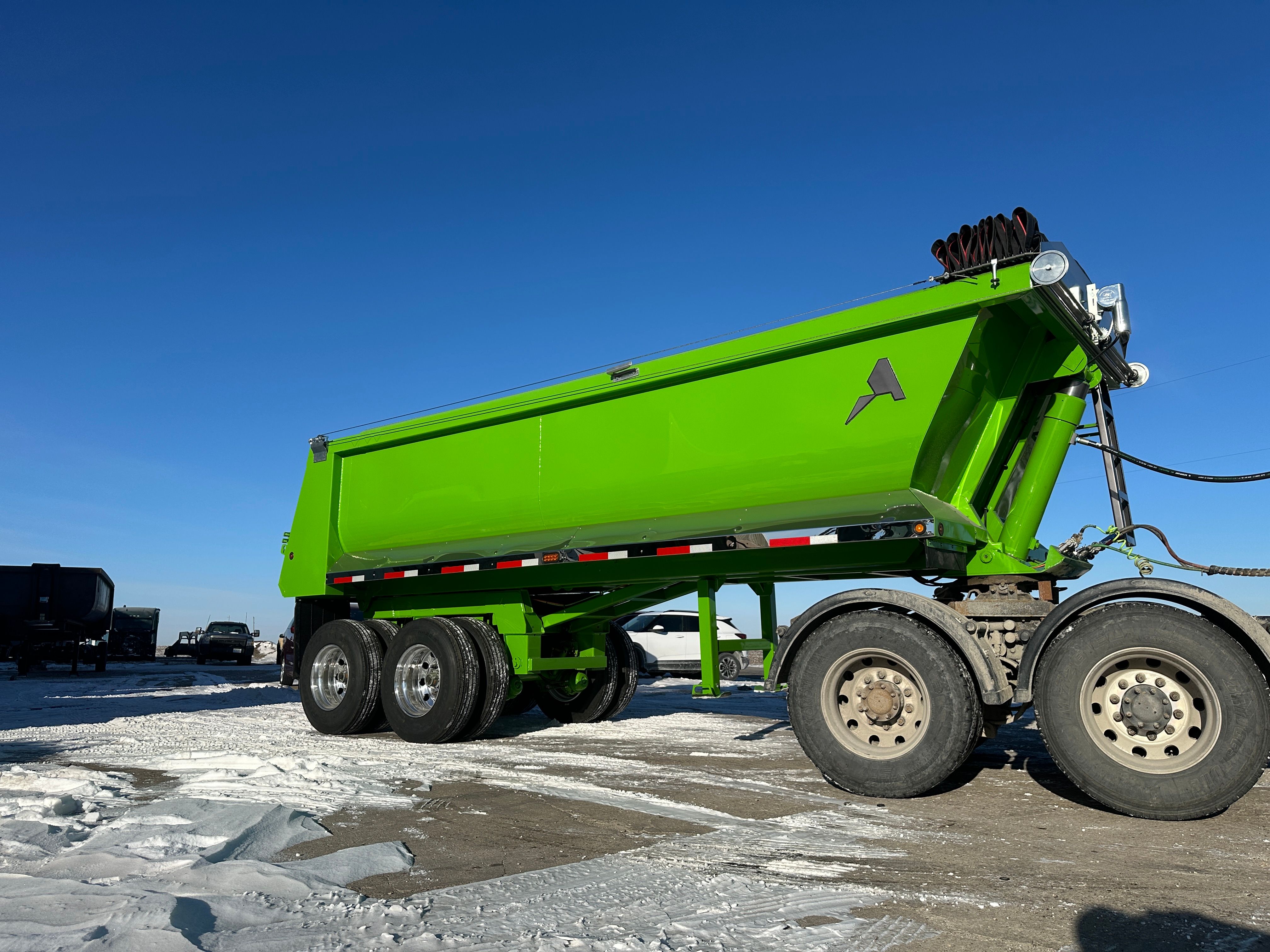 ALKO full frame dump trailer loading armor stone on a Cedar Rapids flood protection project
