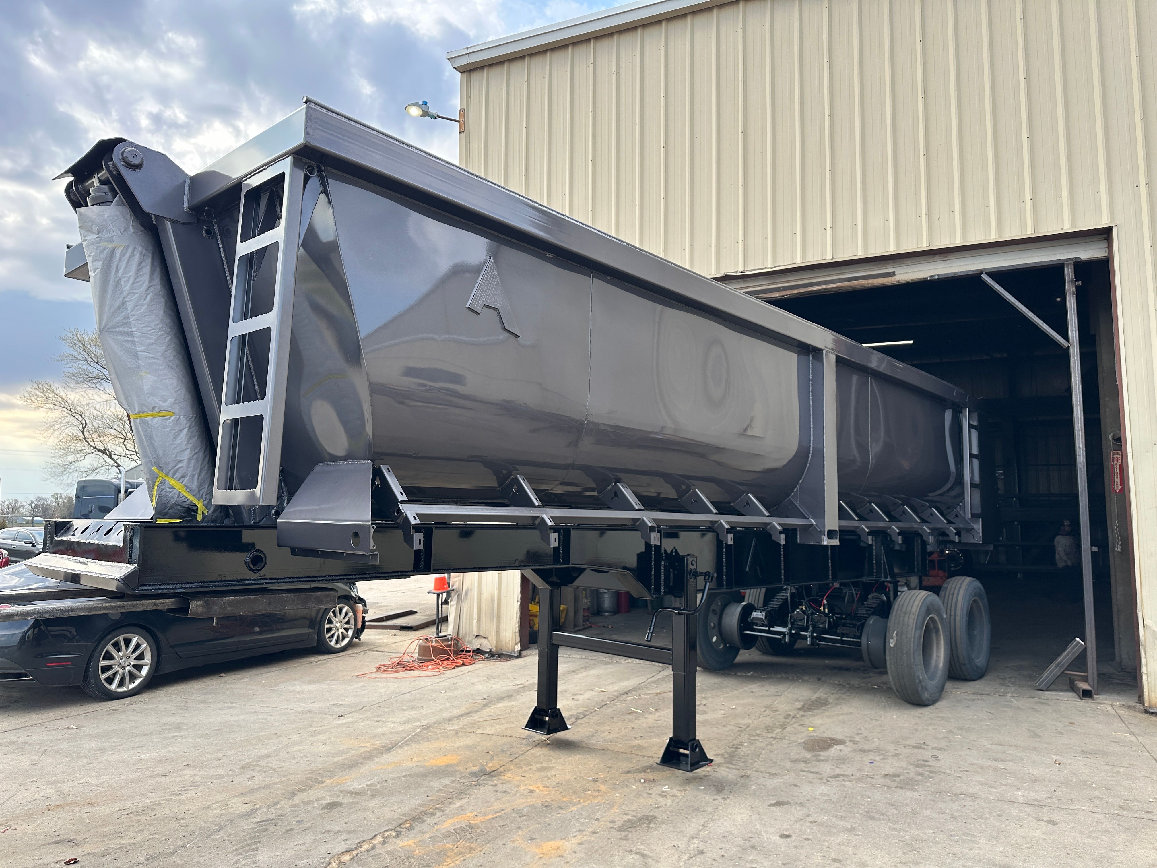 Dump trailer hauling rip rap on a Cedar Rapids levee construction site