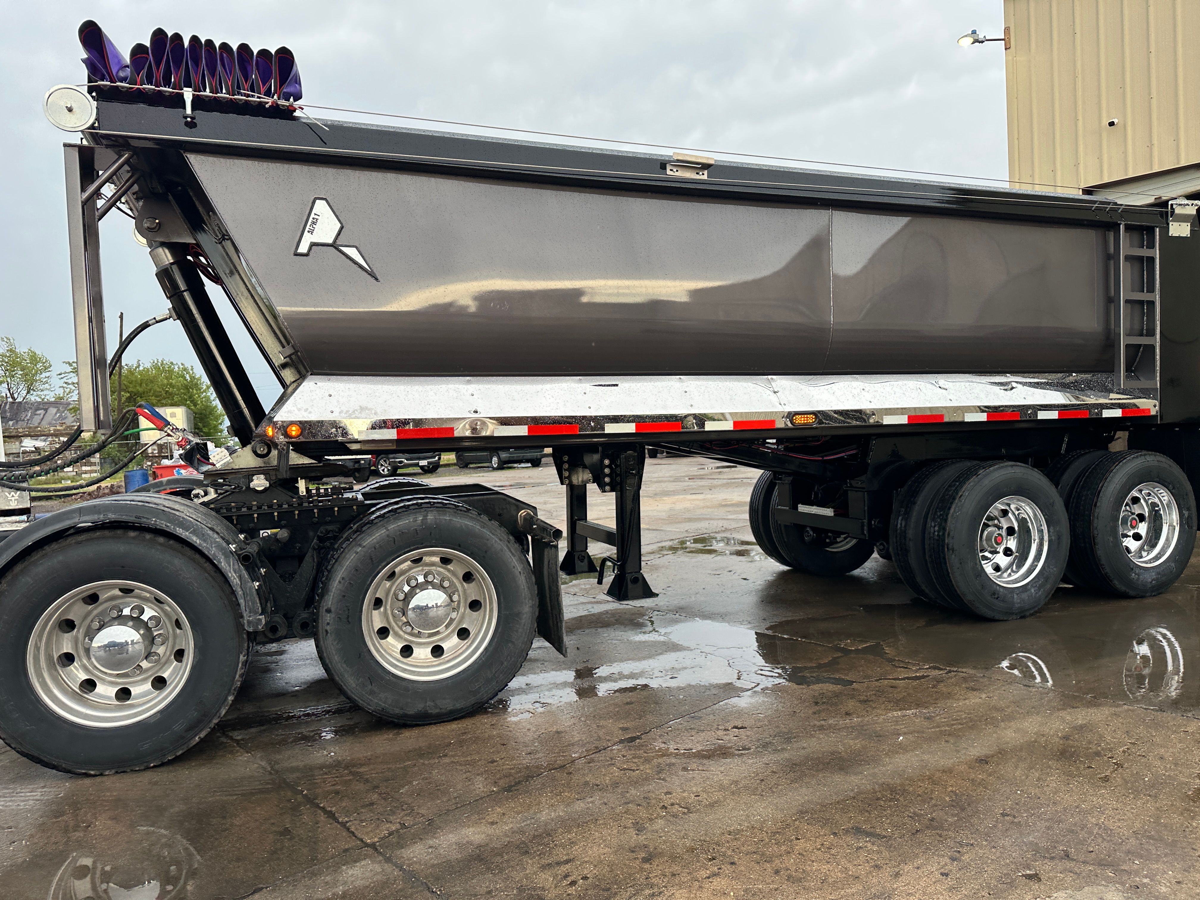 ALKO full frame dump trailer loading armor stone on a Cedar Rapids flood protection project