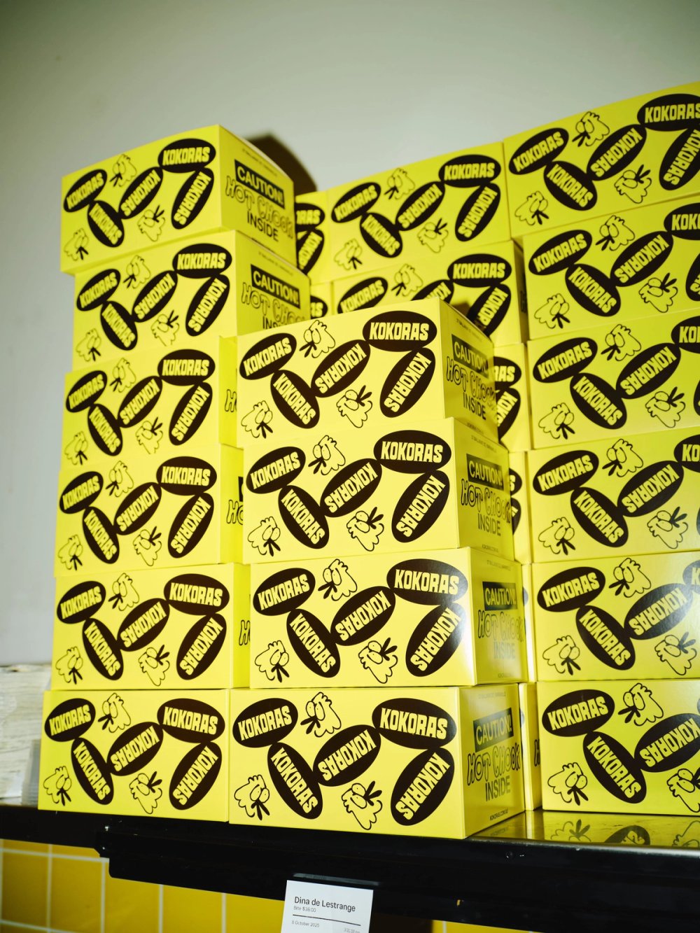 A stack of yellow Kokoras chicken boxes