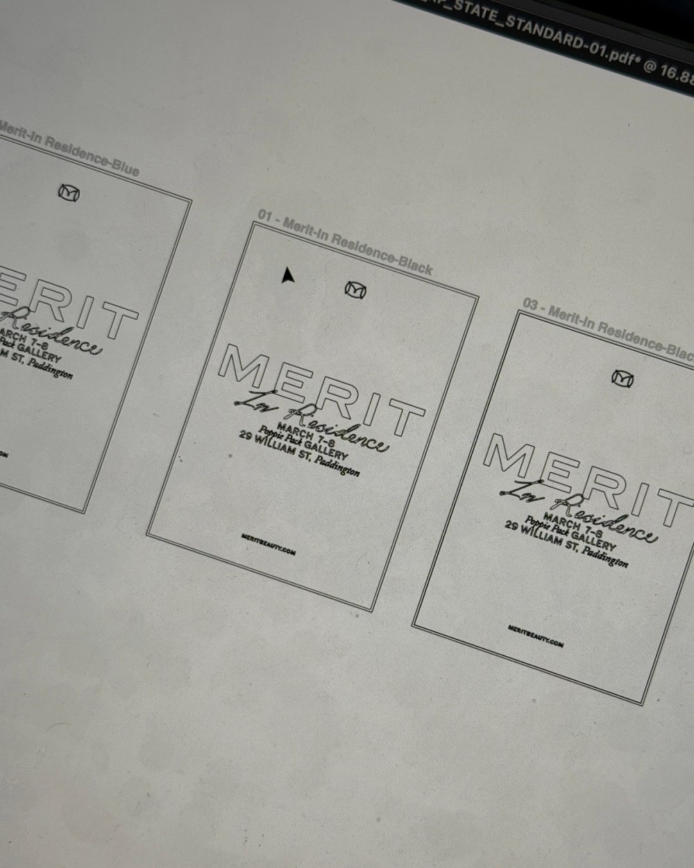 Printed proofs of the MERIT In Residence poster laid side by side