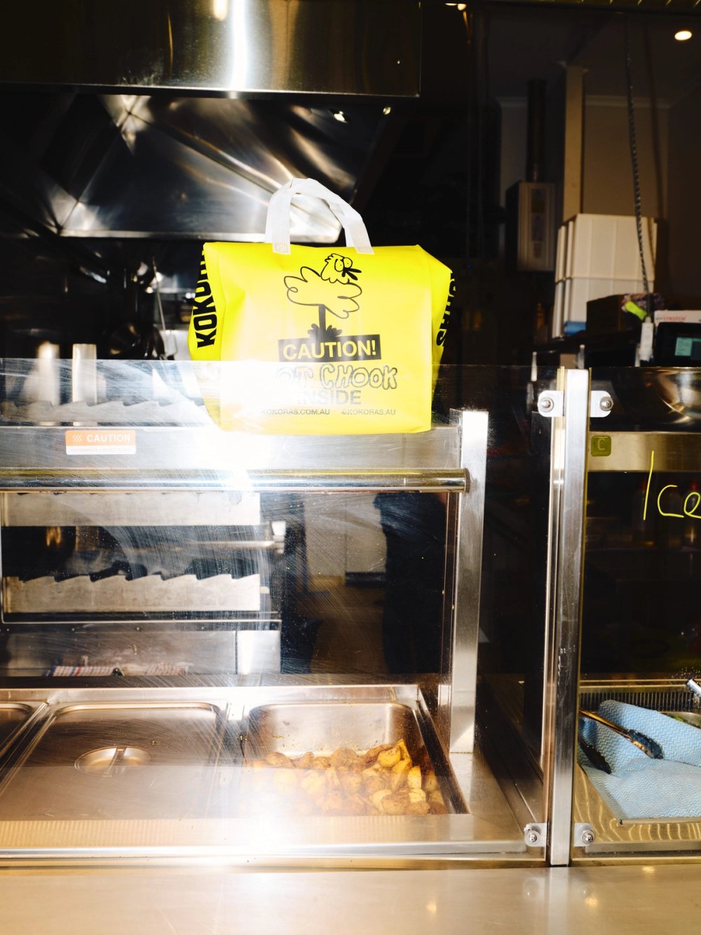 Kokoras bag on the counter above the rotisserie