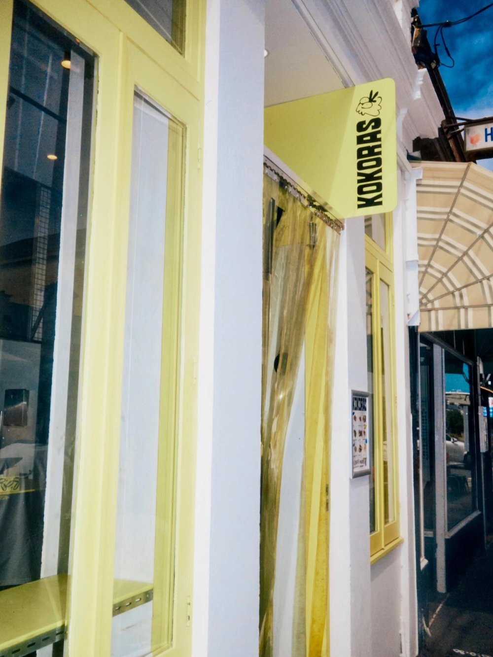 The Kokoras sign above the yellow shopfront