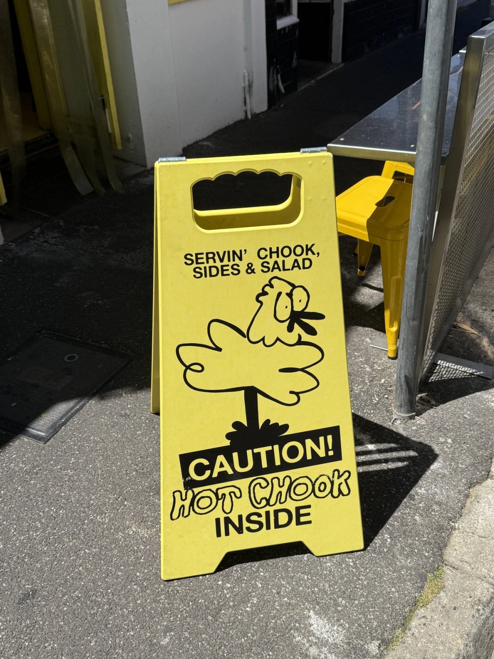 Kokoras "Caution! Hot chook inside" sign on the footpath