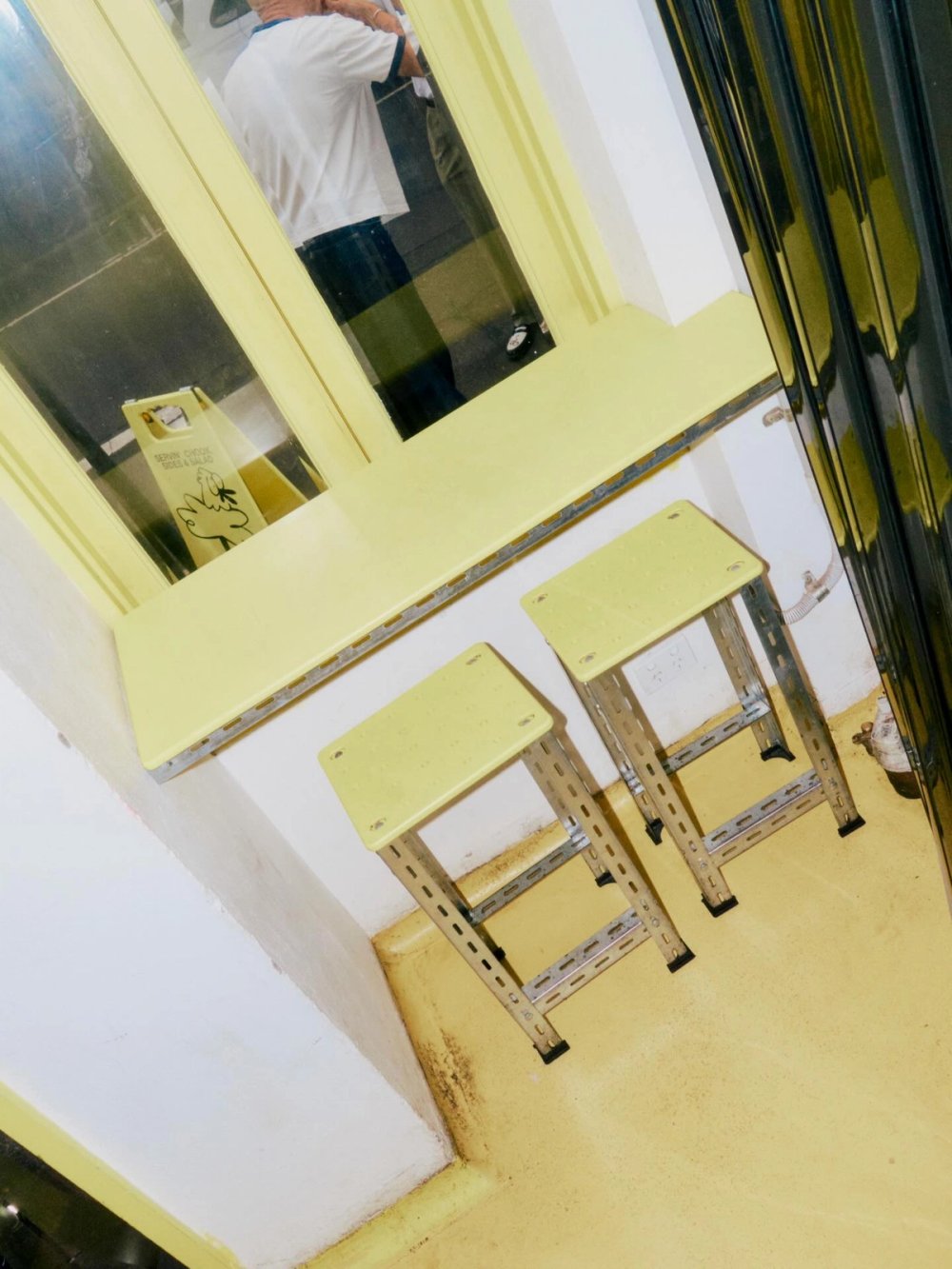 Yellow stools and window ledge inside Kokoras