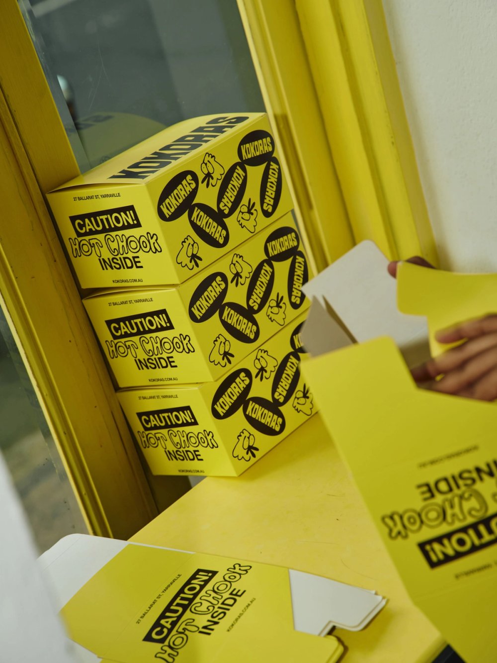 Kokoras boxes being folded at the window