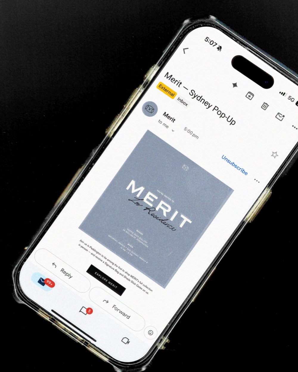 A phone showing the MERIT Sydney pop-up email on black