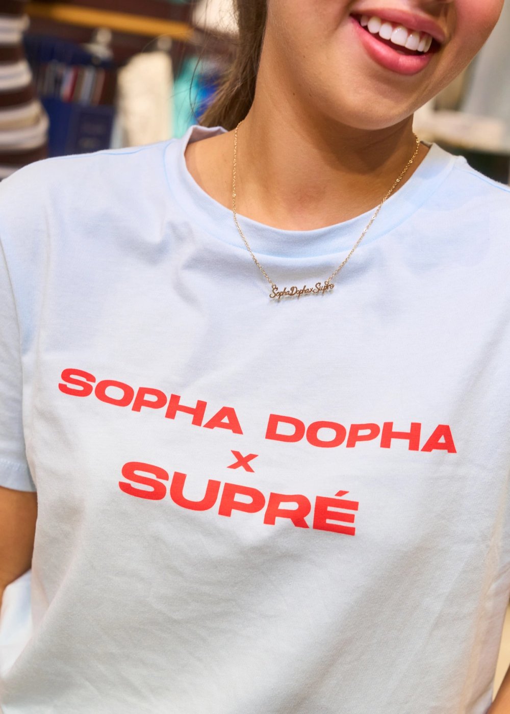 A guest in the light blue Sopha Dopha x Supré T-shirt and name necklace
