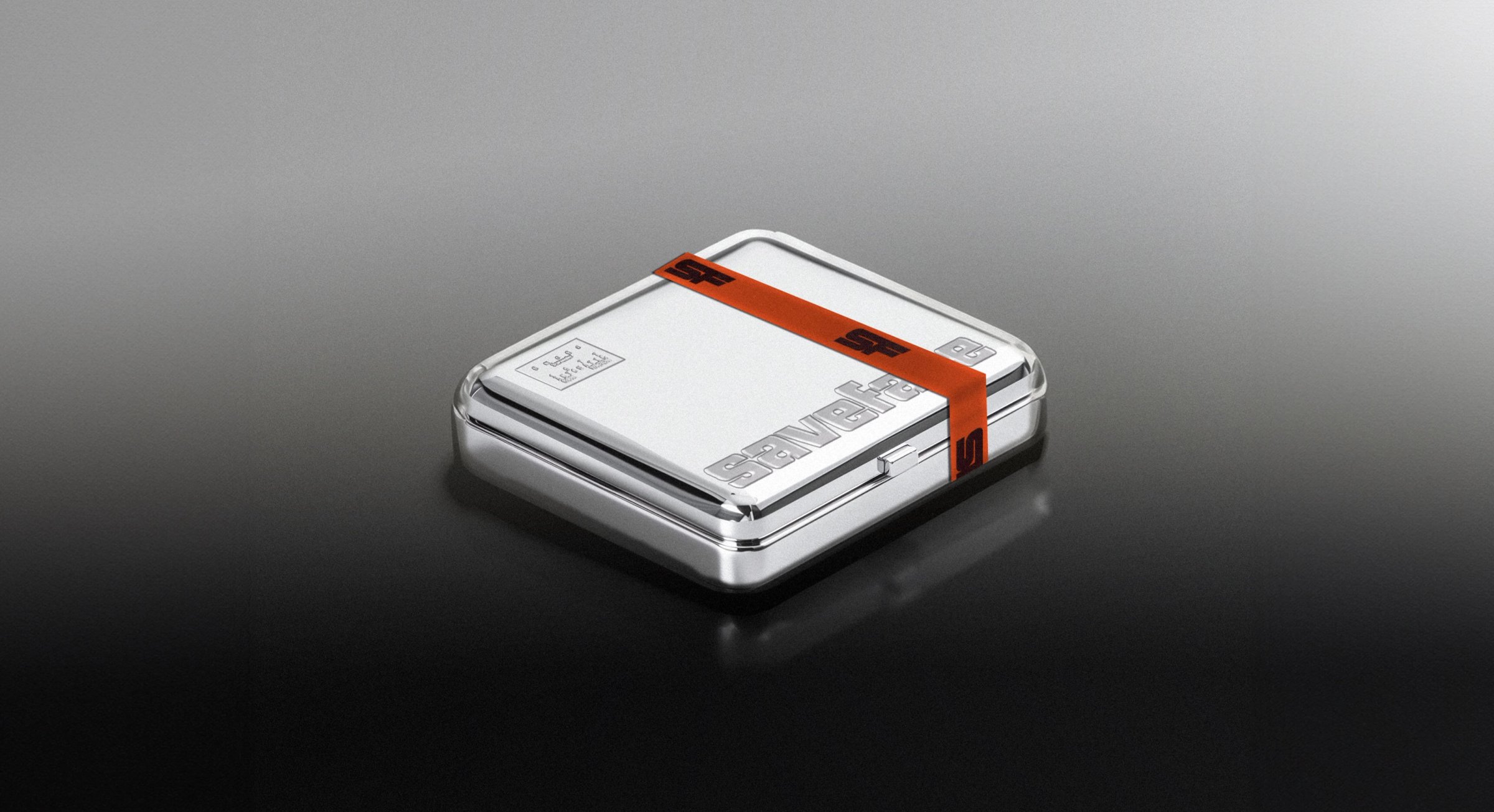 Chrome watch tin wrapped in an orange Saveface band