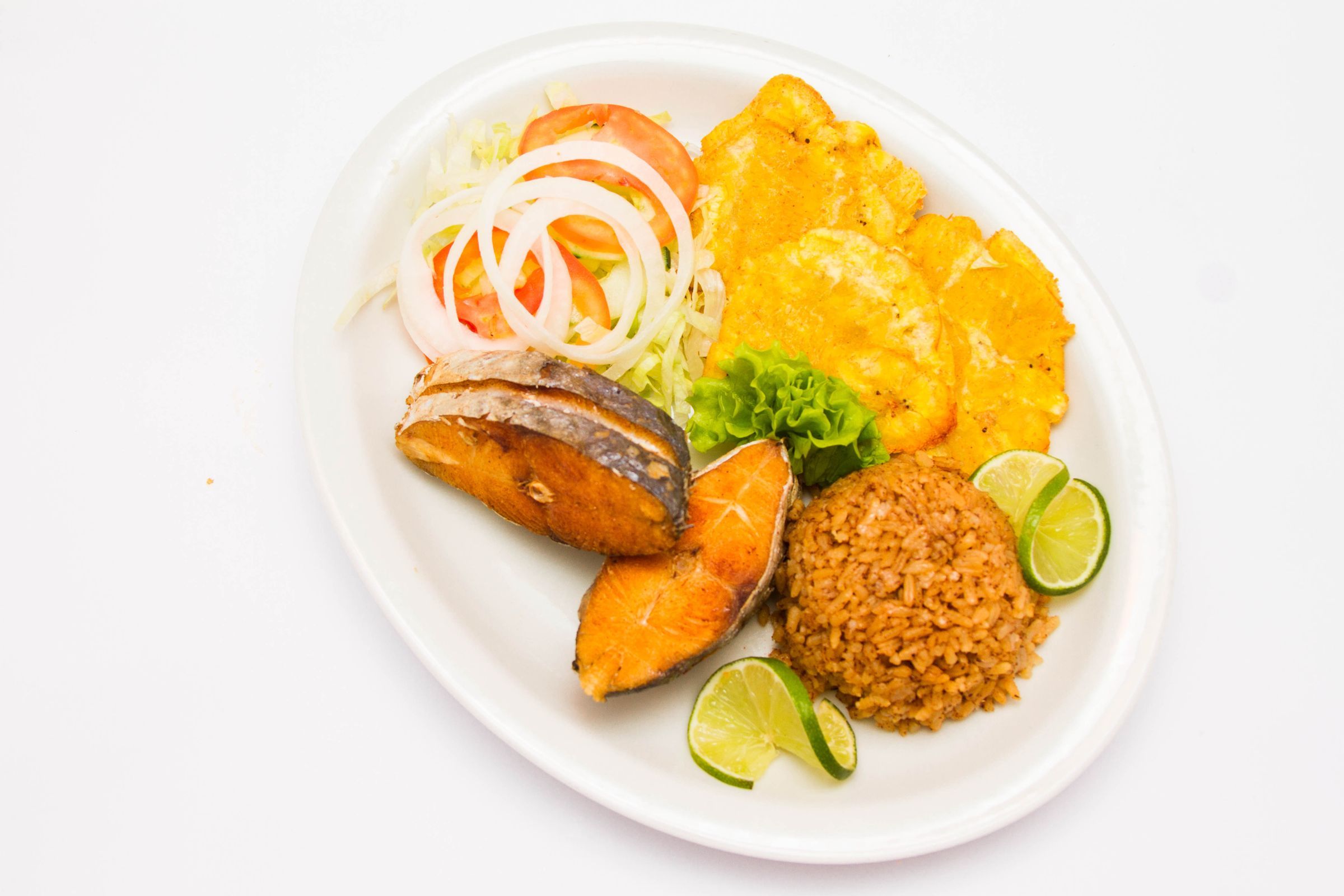 A plate of fish, rice and vegetables.