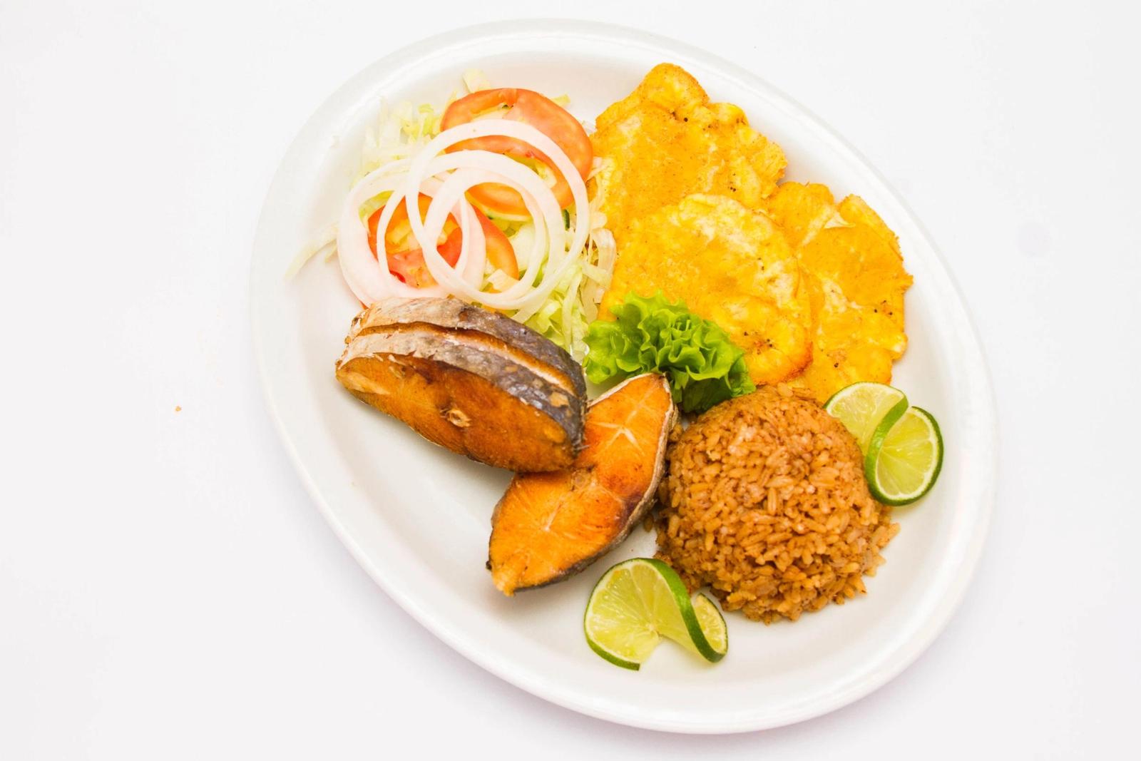A plate of fish, rice and vegetables.