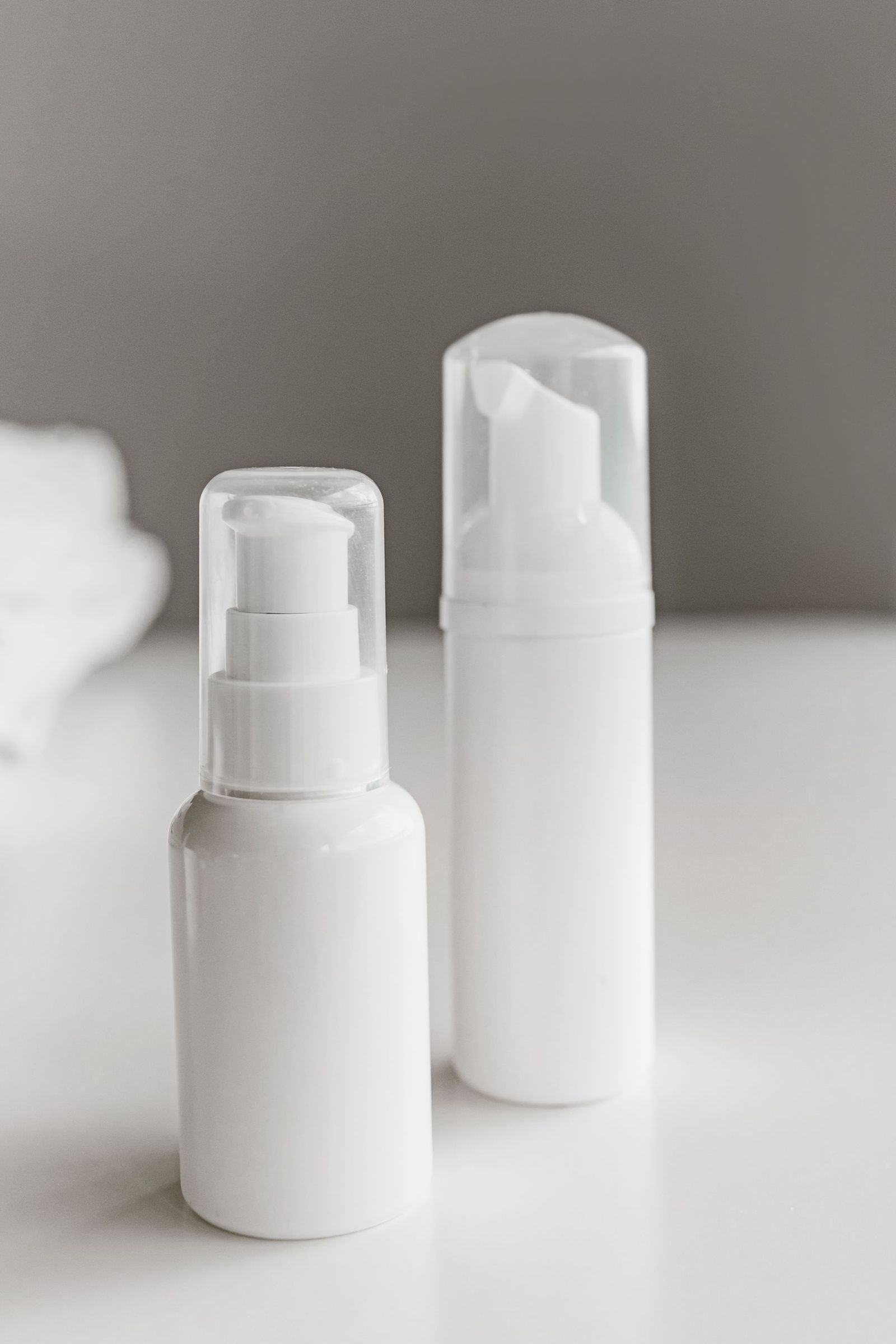 Two plain white pump bottles.